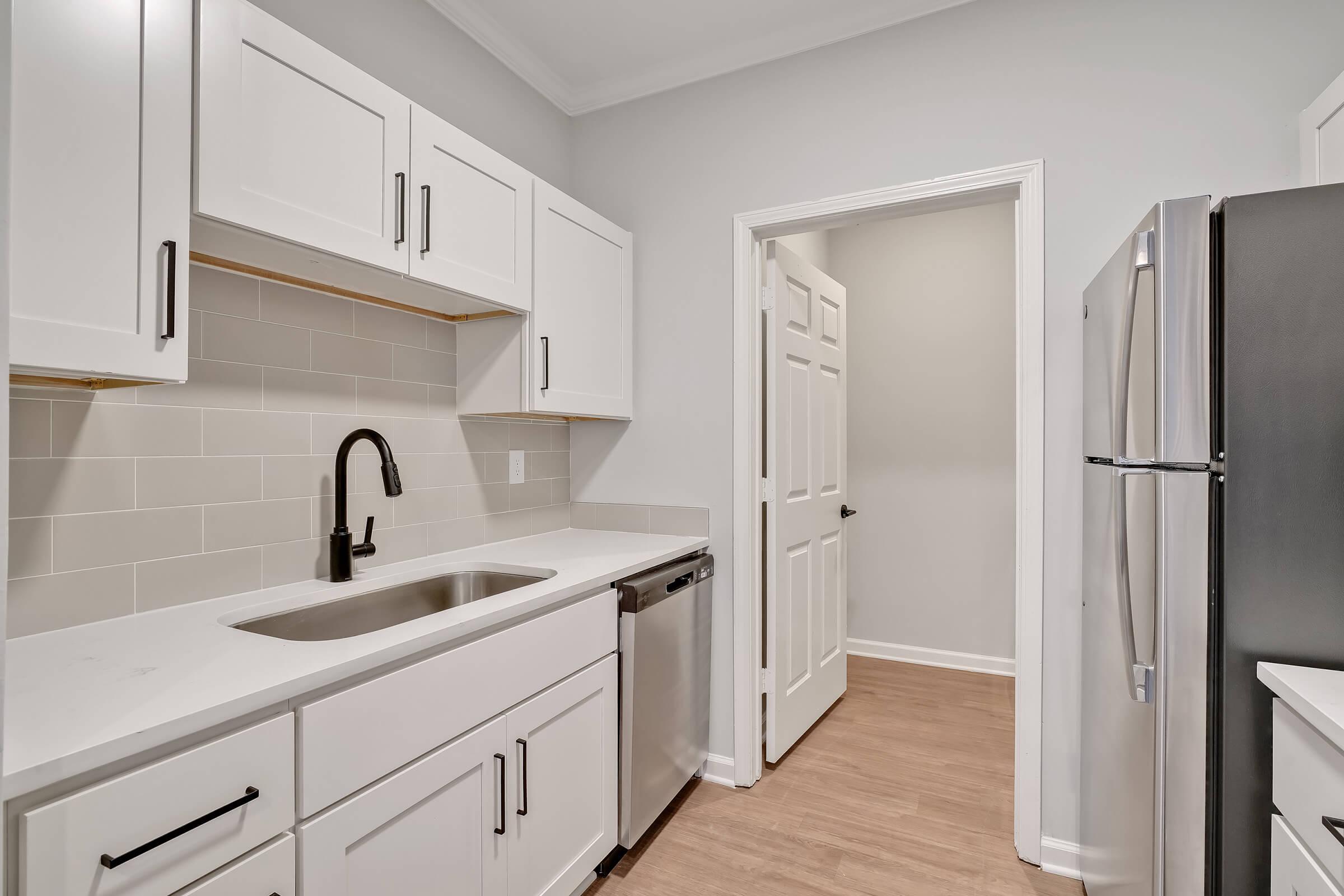 a kitchen with a sink and a refrigerator