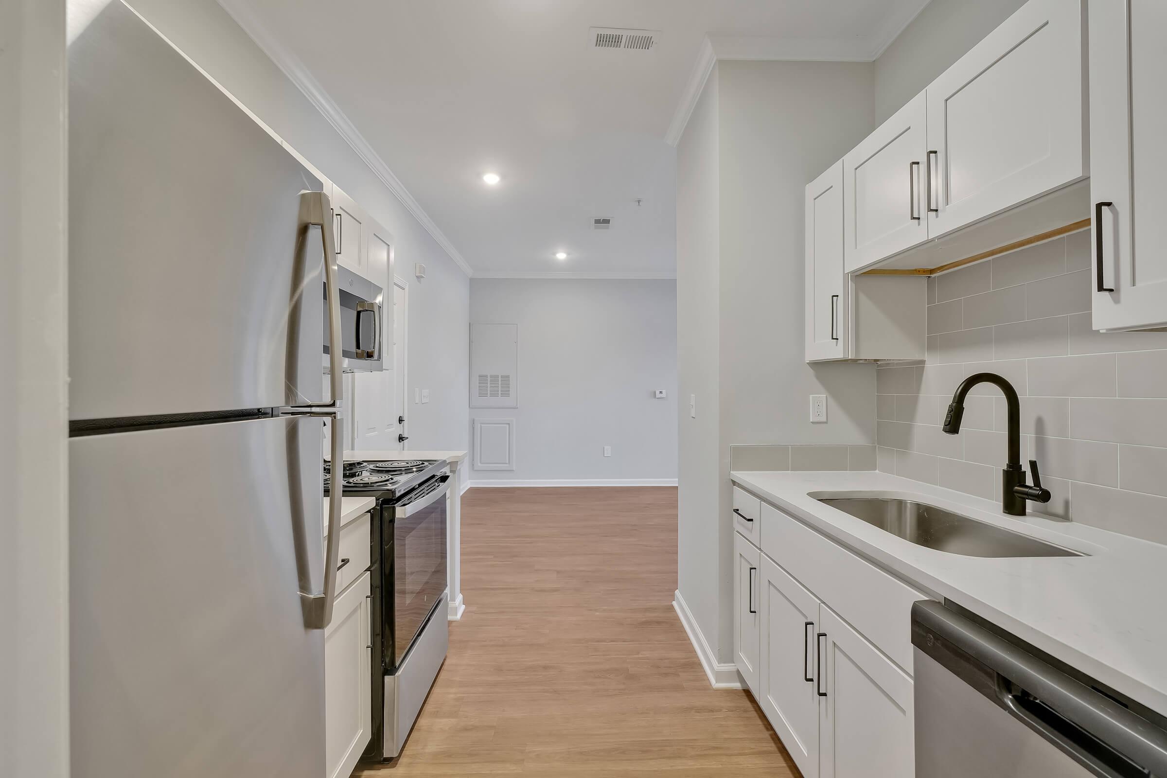 a kitchen with a sink and a refrigerator