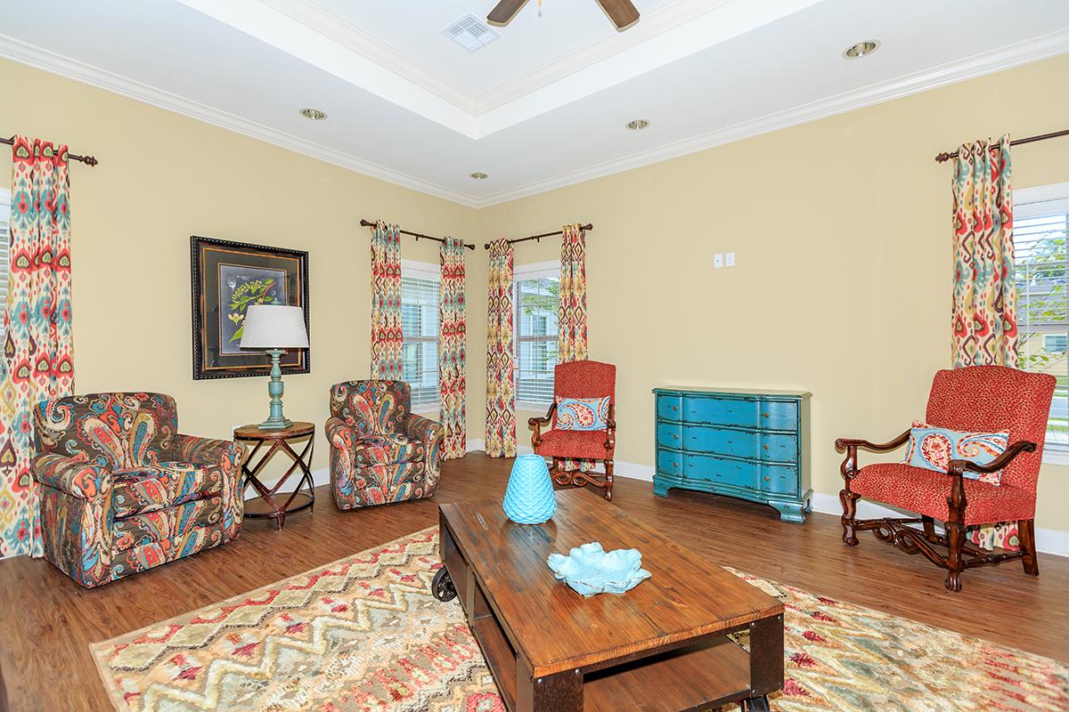 a living room filled with furniture and a flat screen tv