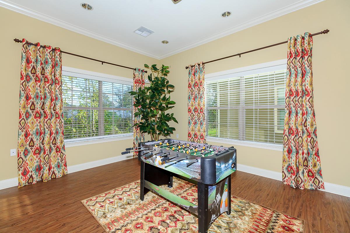 a living room filled with furniture and a flat screen tv