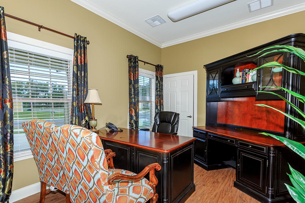 a living room filled with furniture and a tv