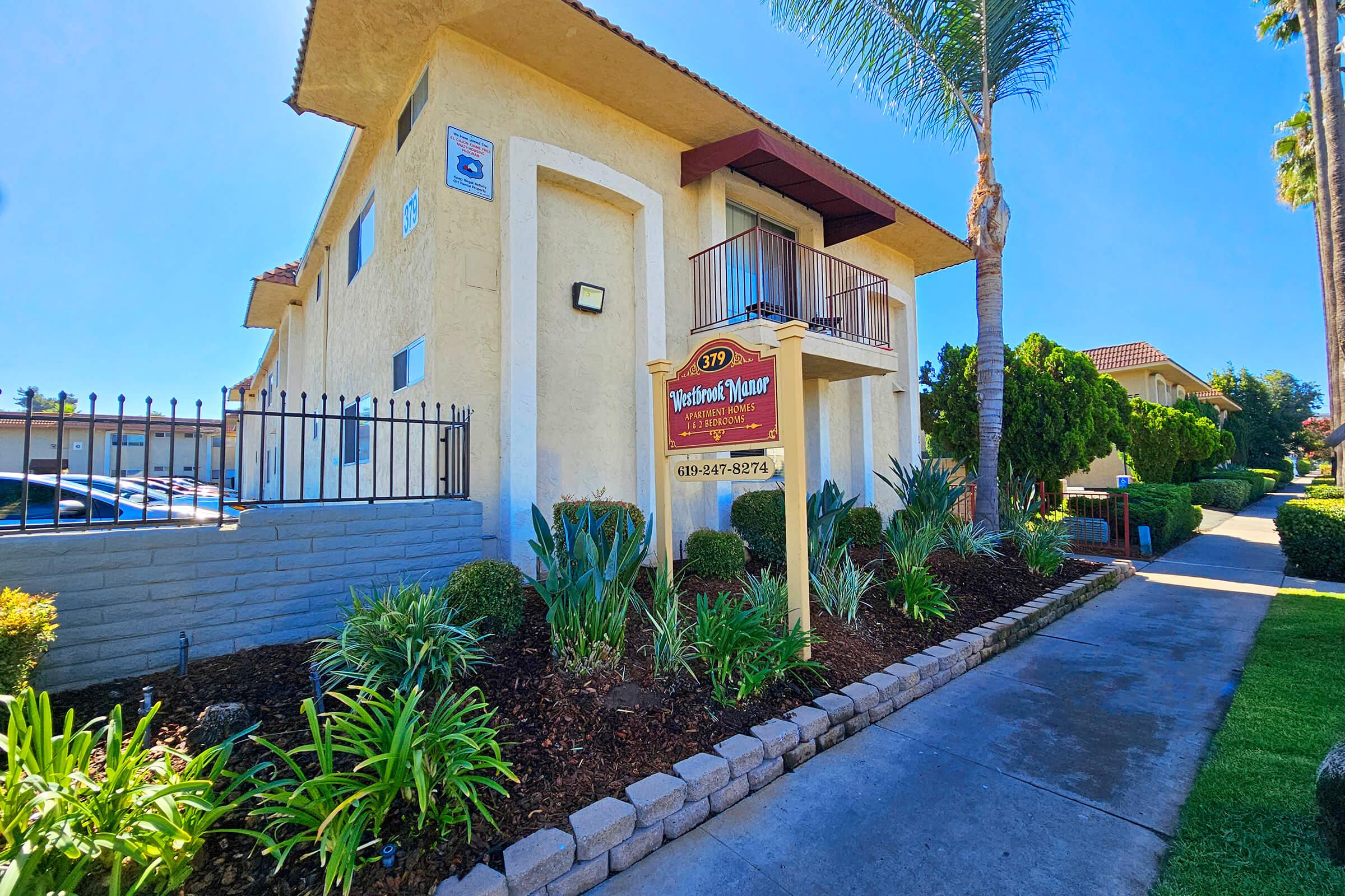 a house that has a sign on the side of a building