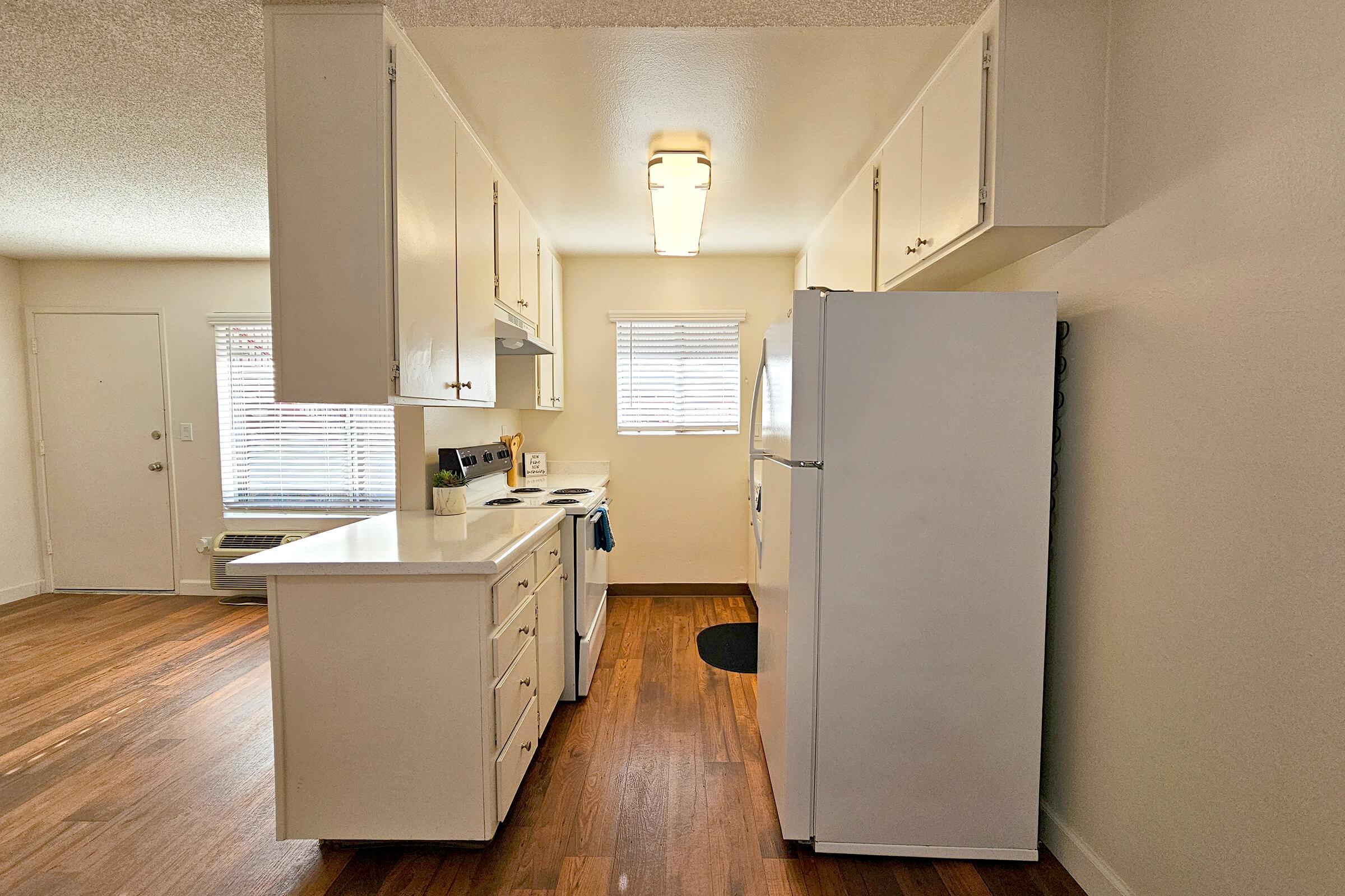 a kitchen with a sink and a refrigerator