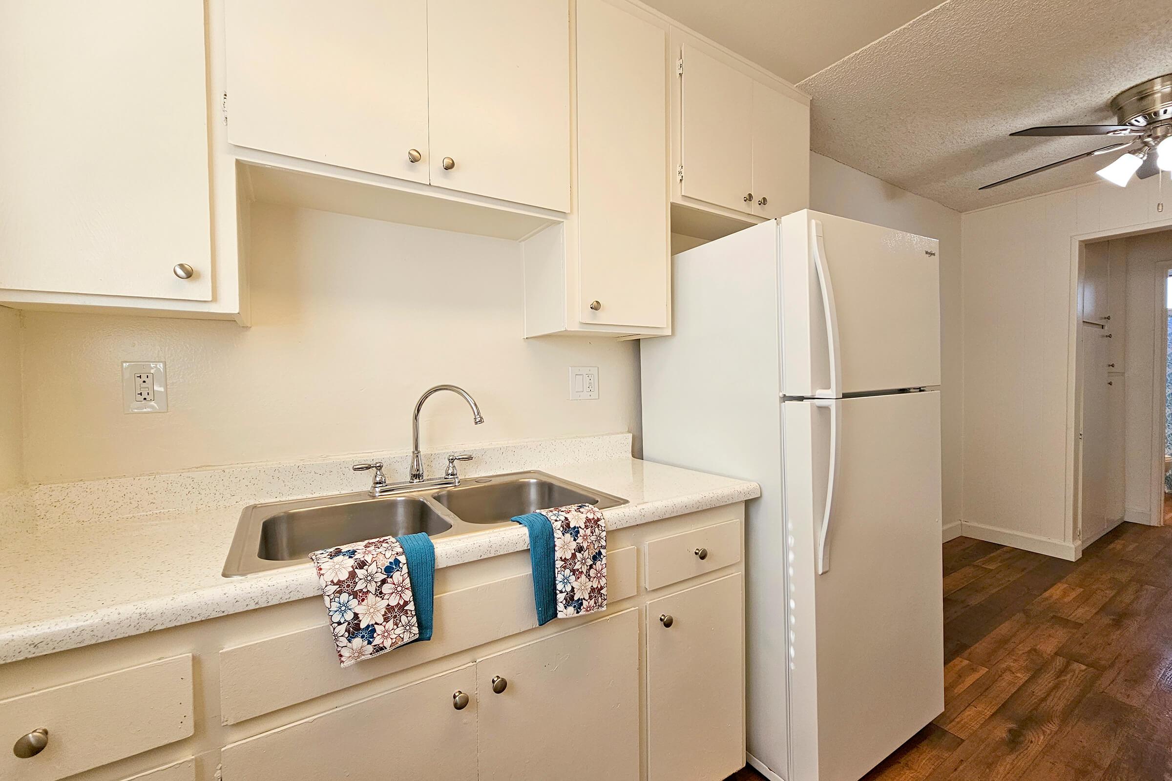 a kitchen with a sink and a mirror