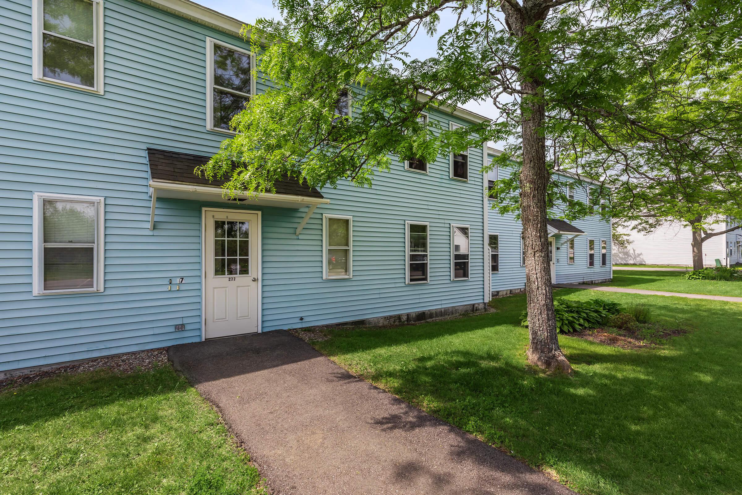 a house with a lawn in front of a building