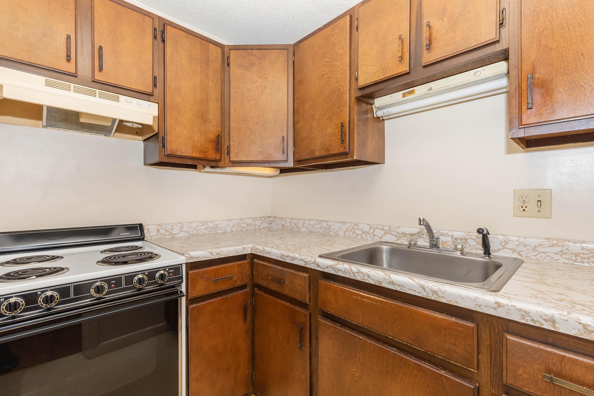 a kitchen with a stove and a sink