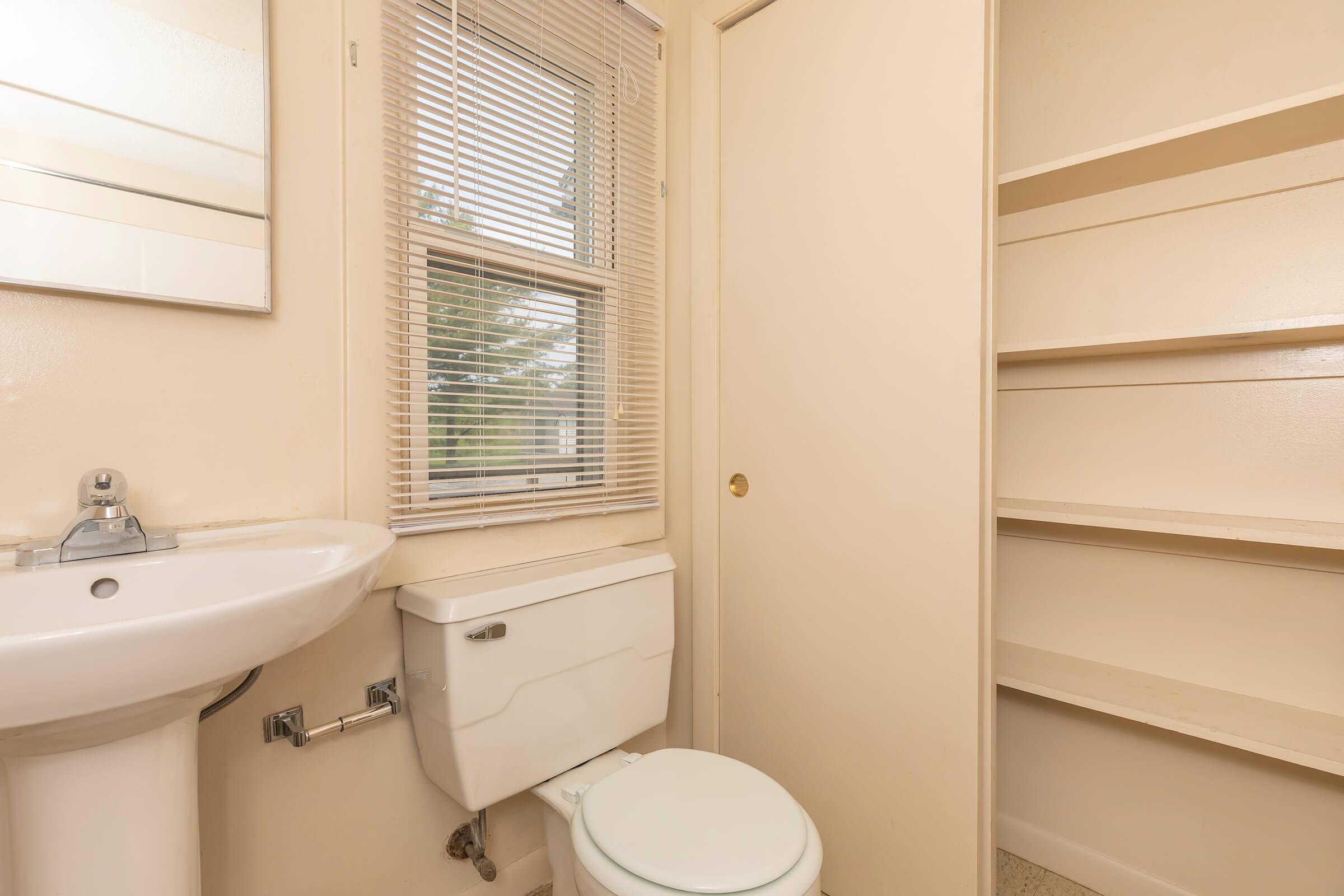 a white sink sitting under a window