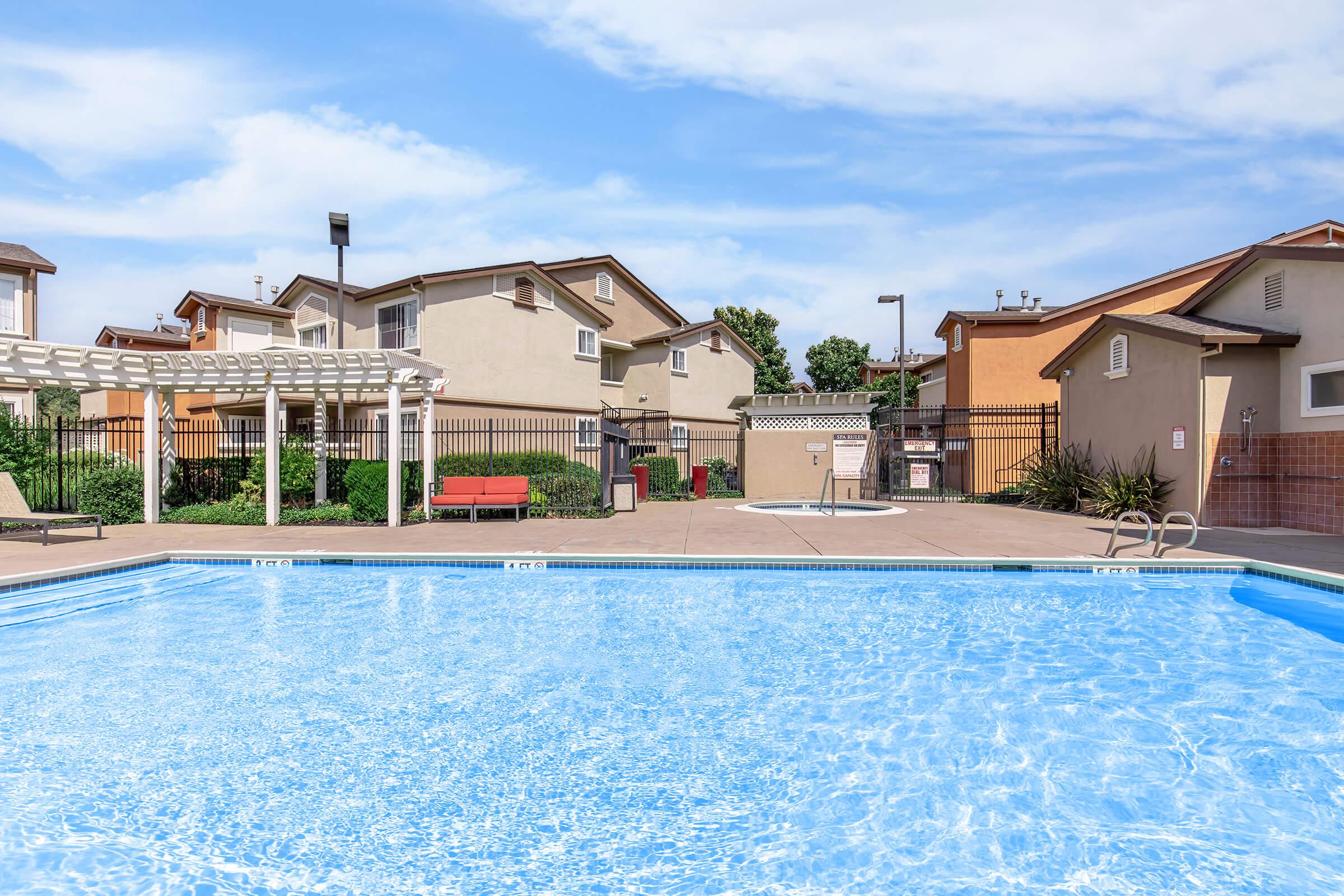 a house with a pool in front of a building