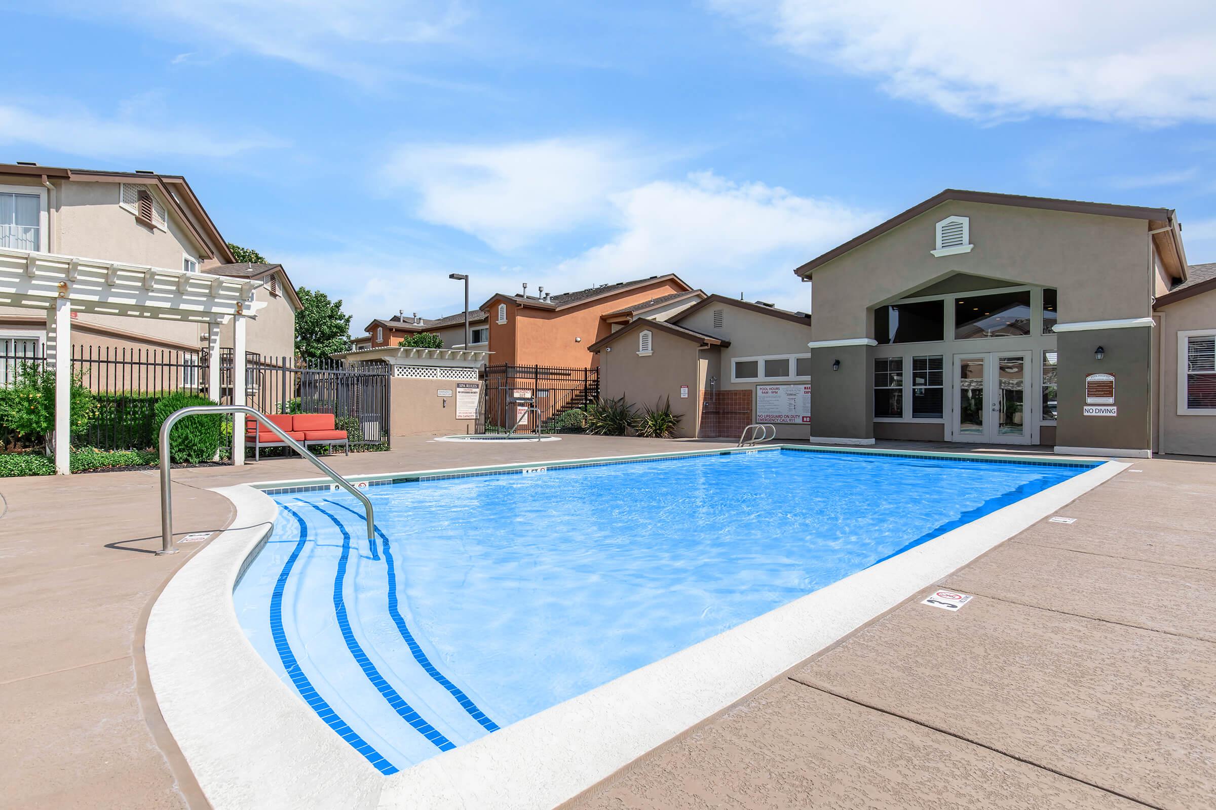 a house with a pool in front of a building