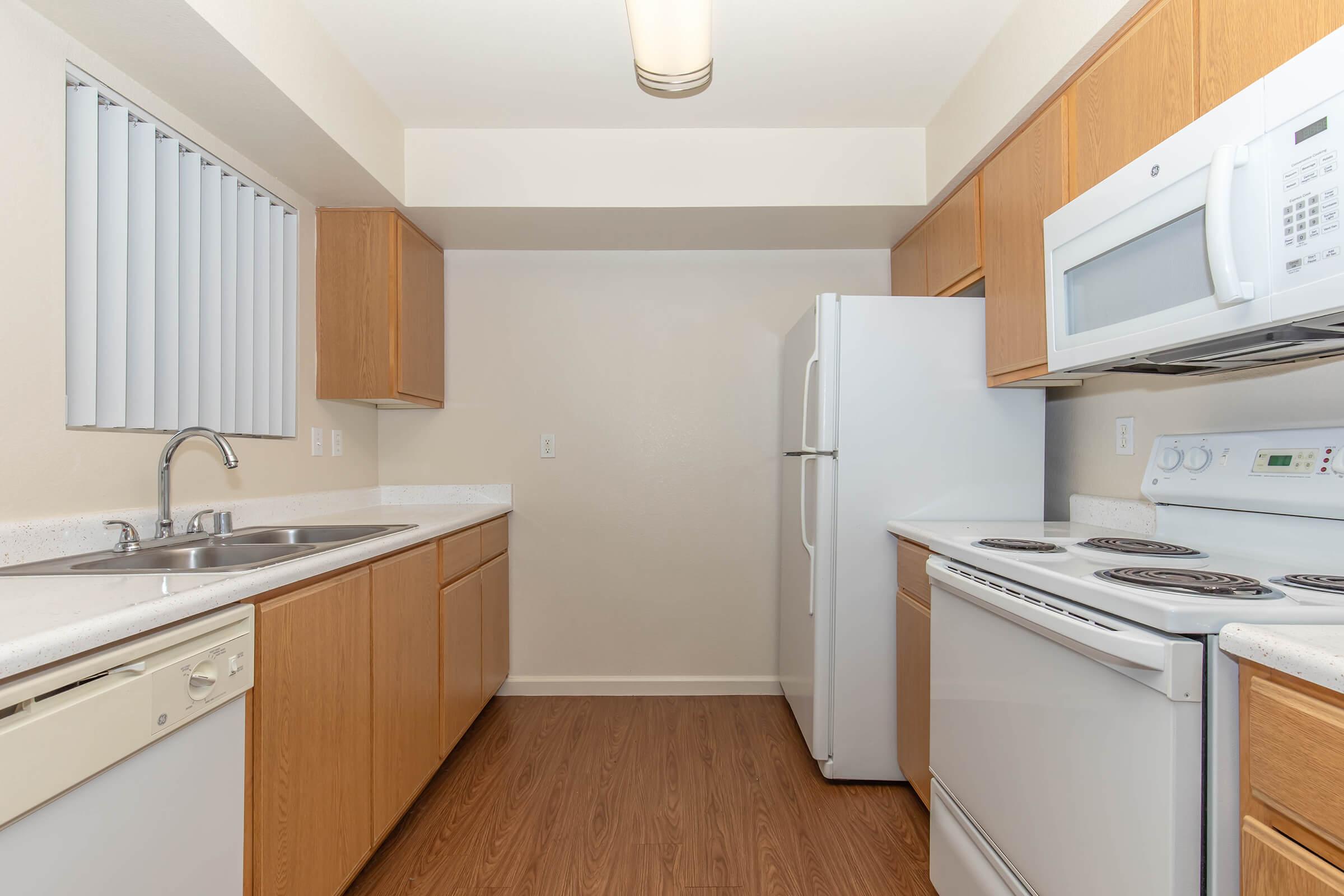 a kitchen with a stove sink and refrigerator