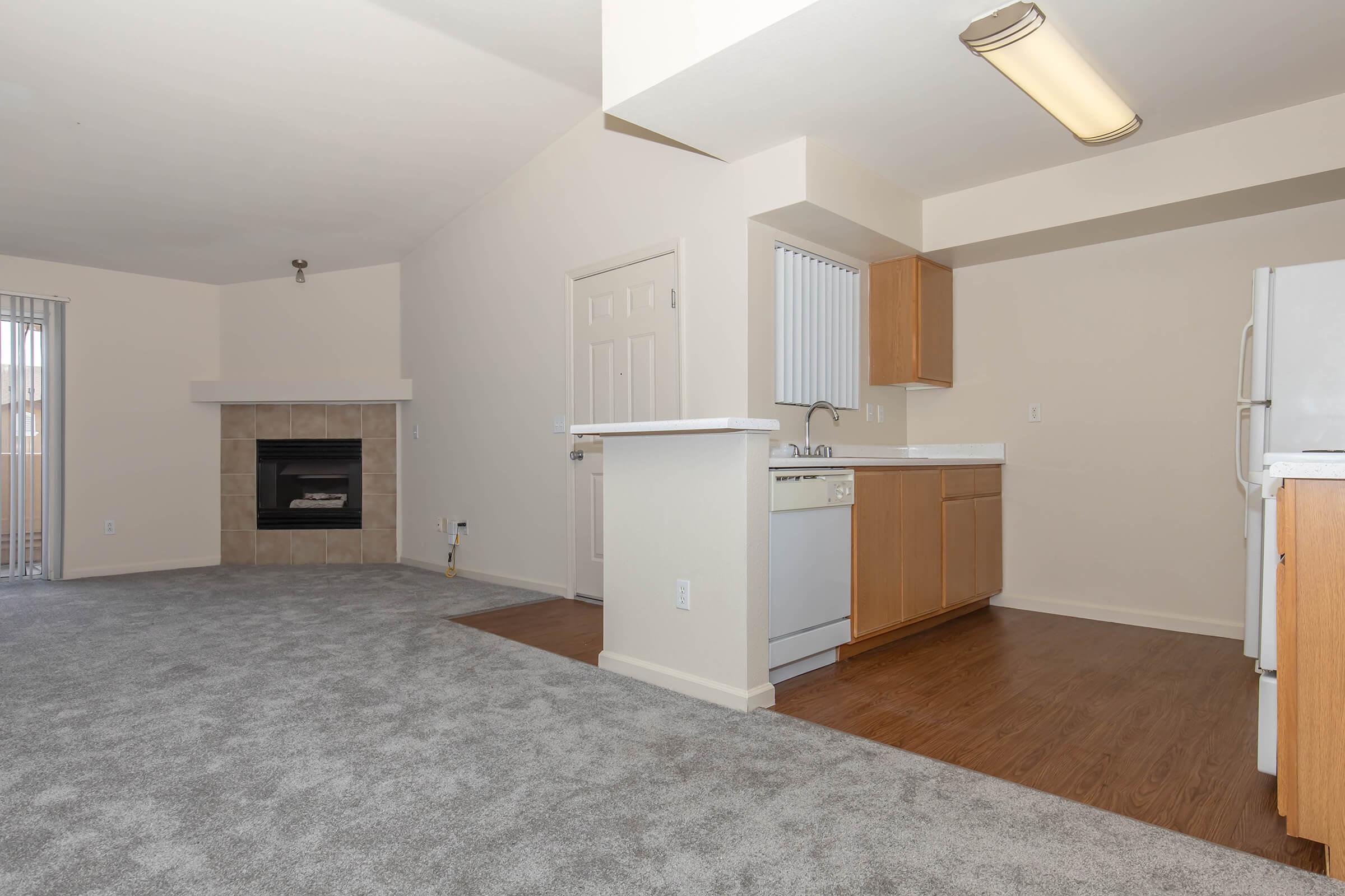 a kitchen with a wood floor in a room