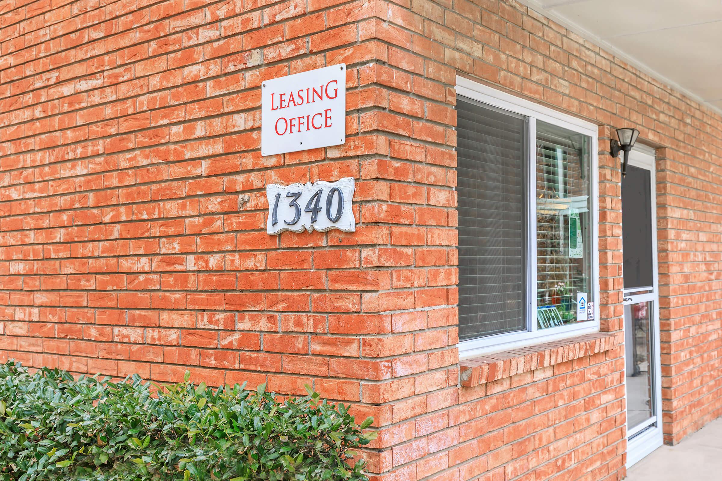 a sign in front of a brick building