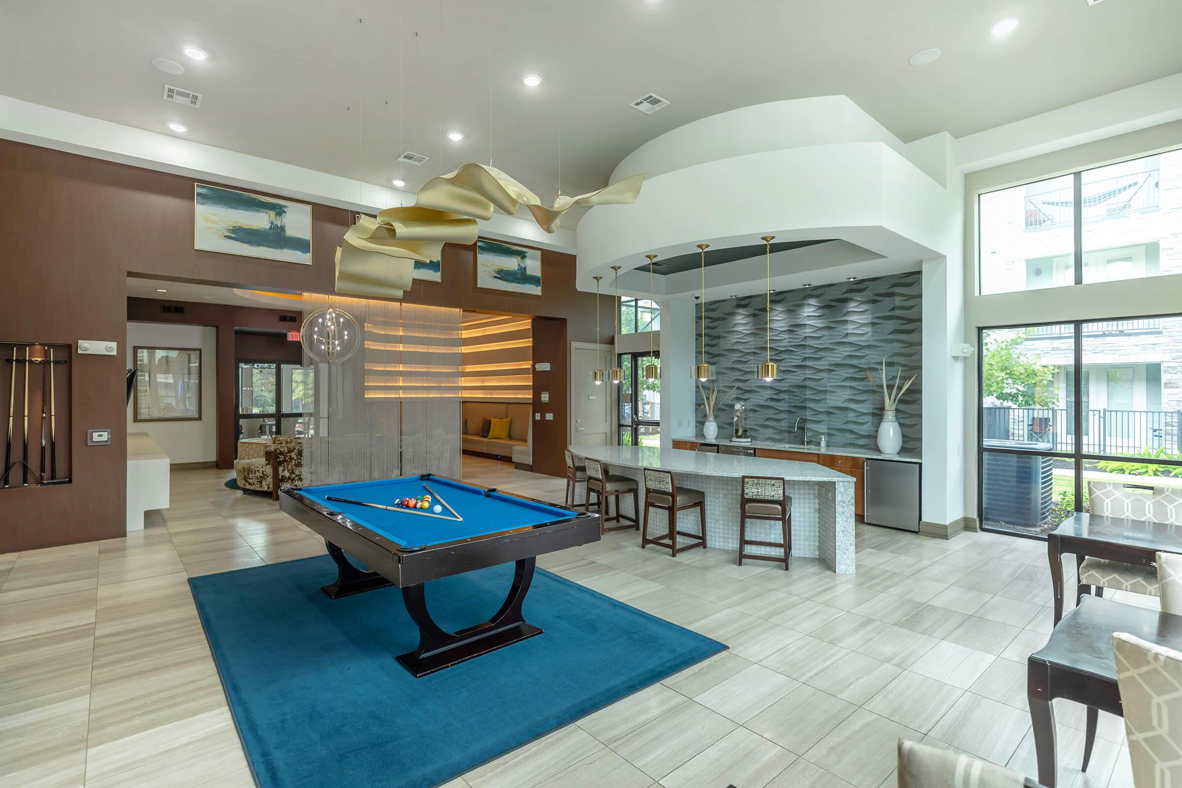 a living room filled with furniture and a pool table
