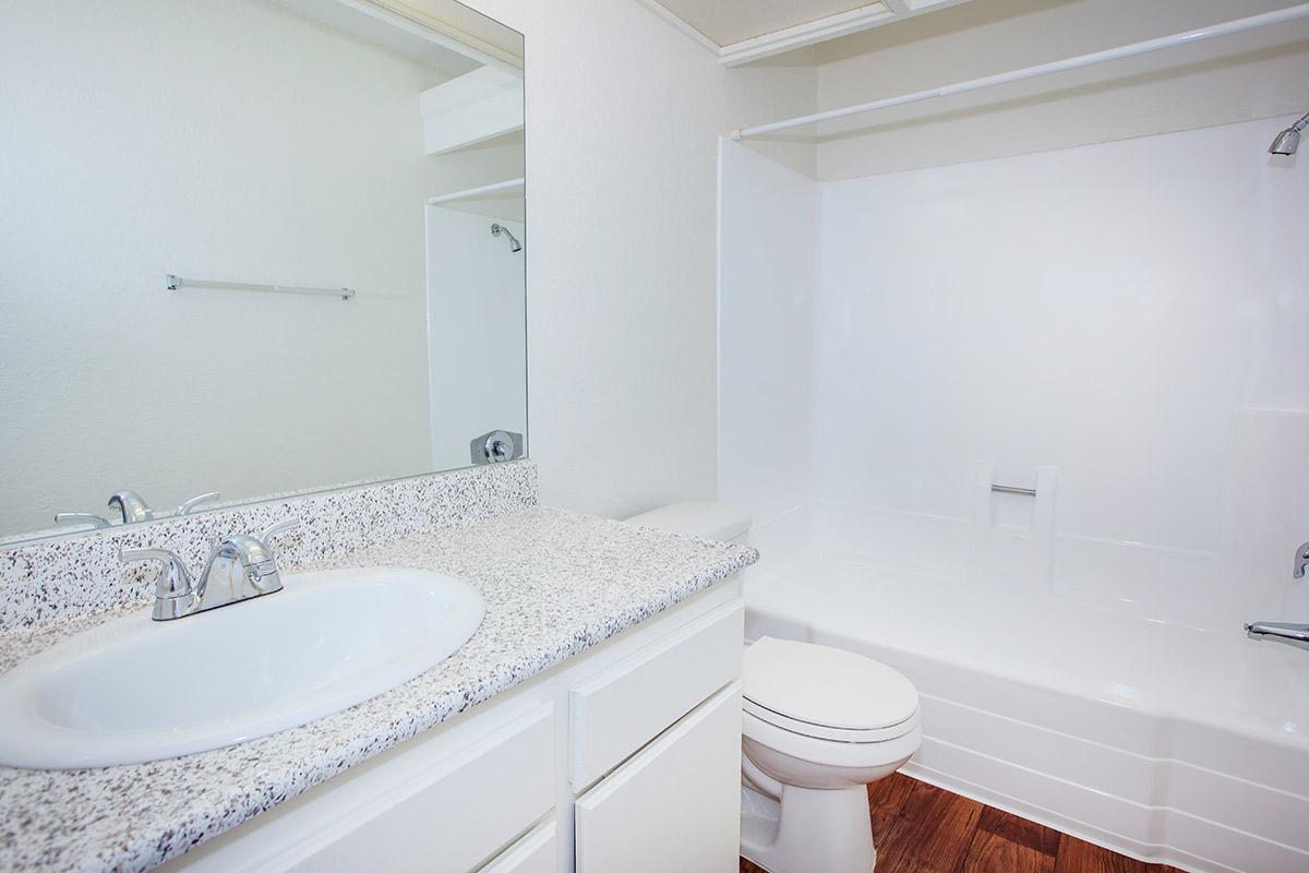 Vacant bathroom with white cabinets