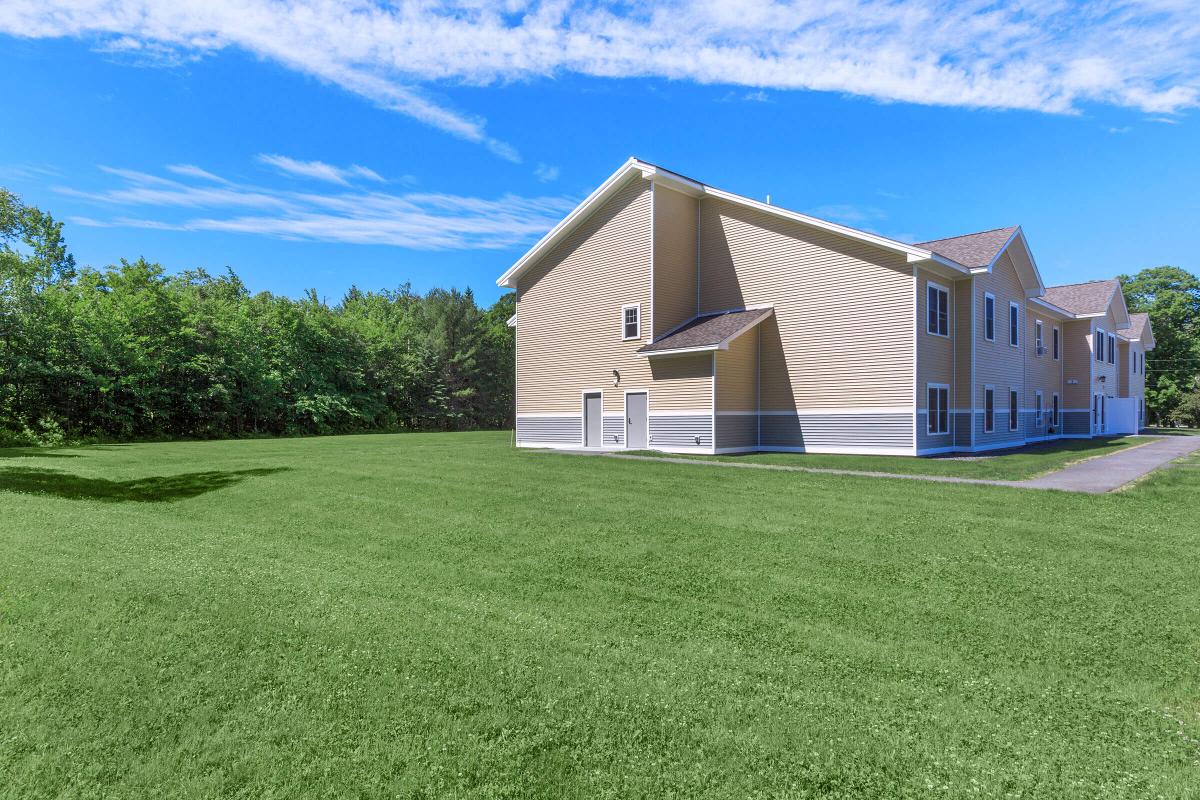 a building with a grassy field