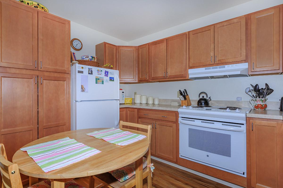 a kitchen with wooden cabinets