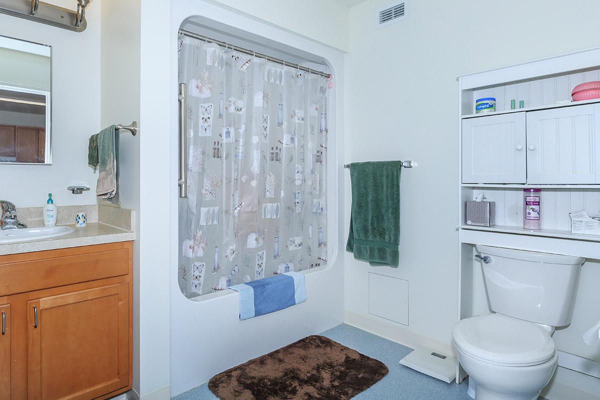 a white tub sitting next to a sink