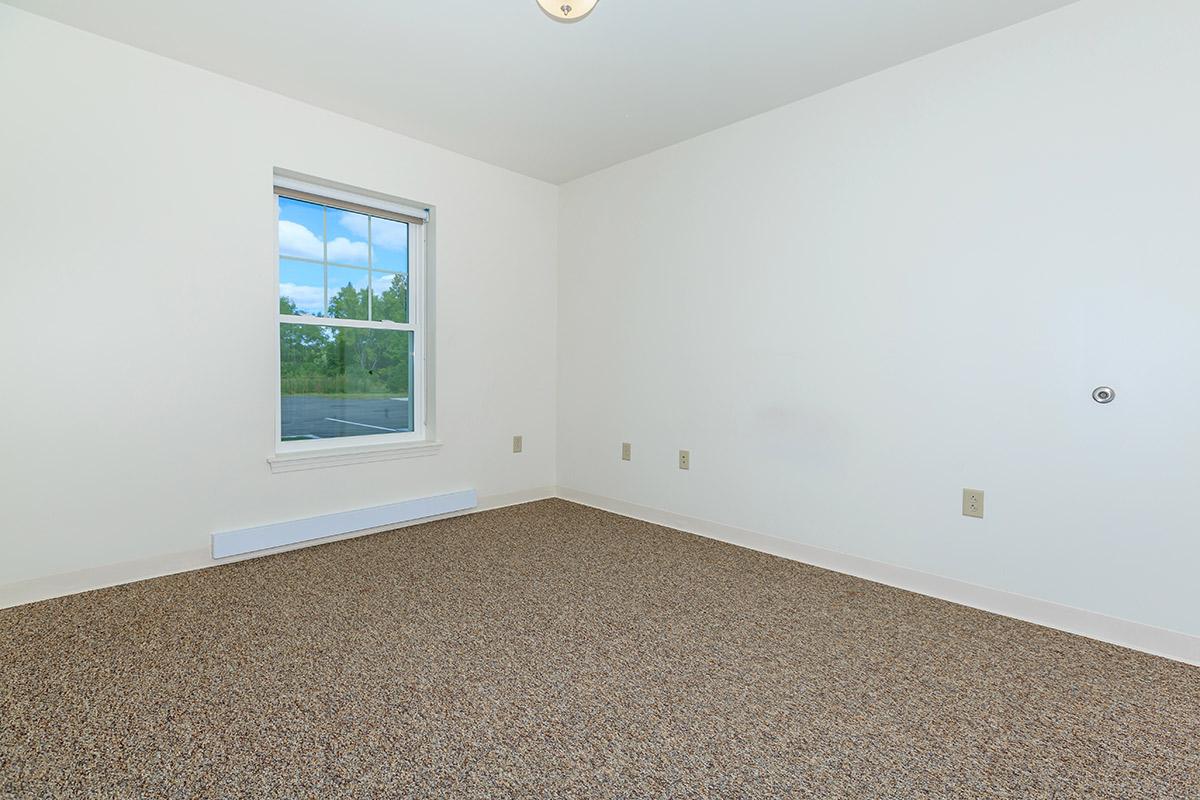 a bedroom with a large window