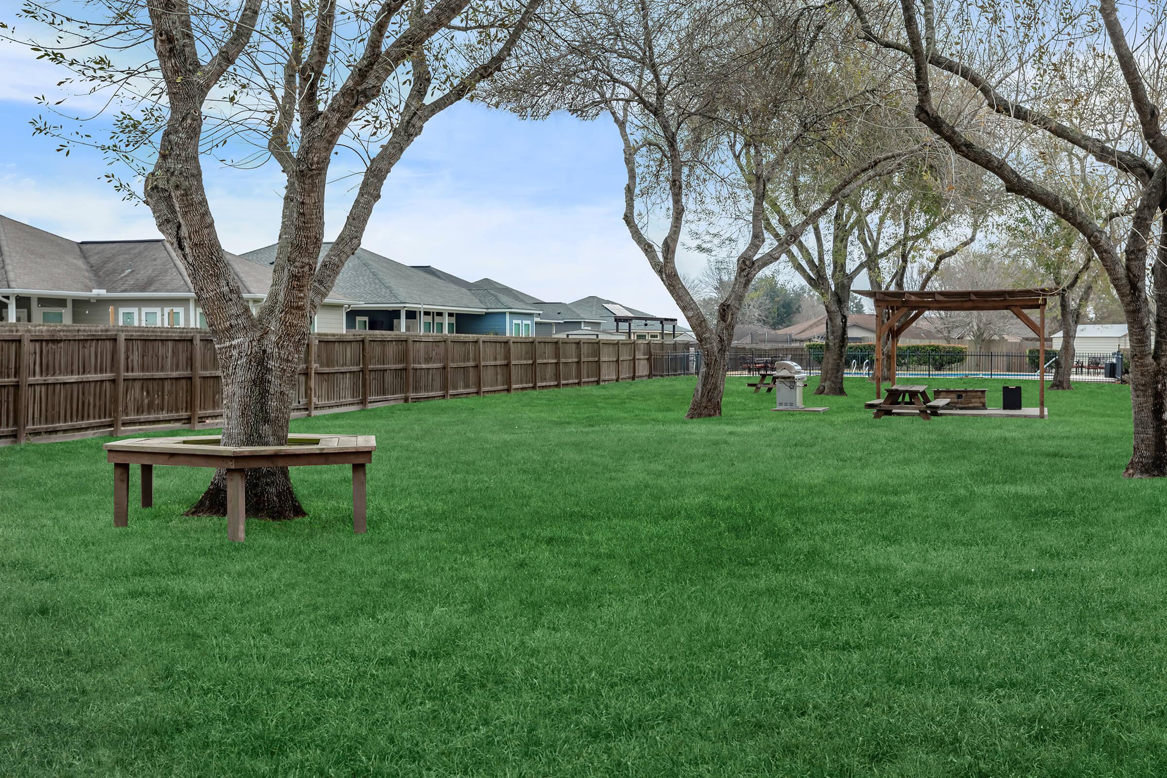 a group of lawn chairs sitting on top of a grass covered field