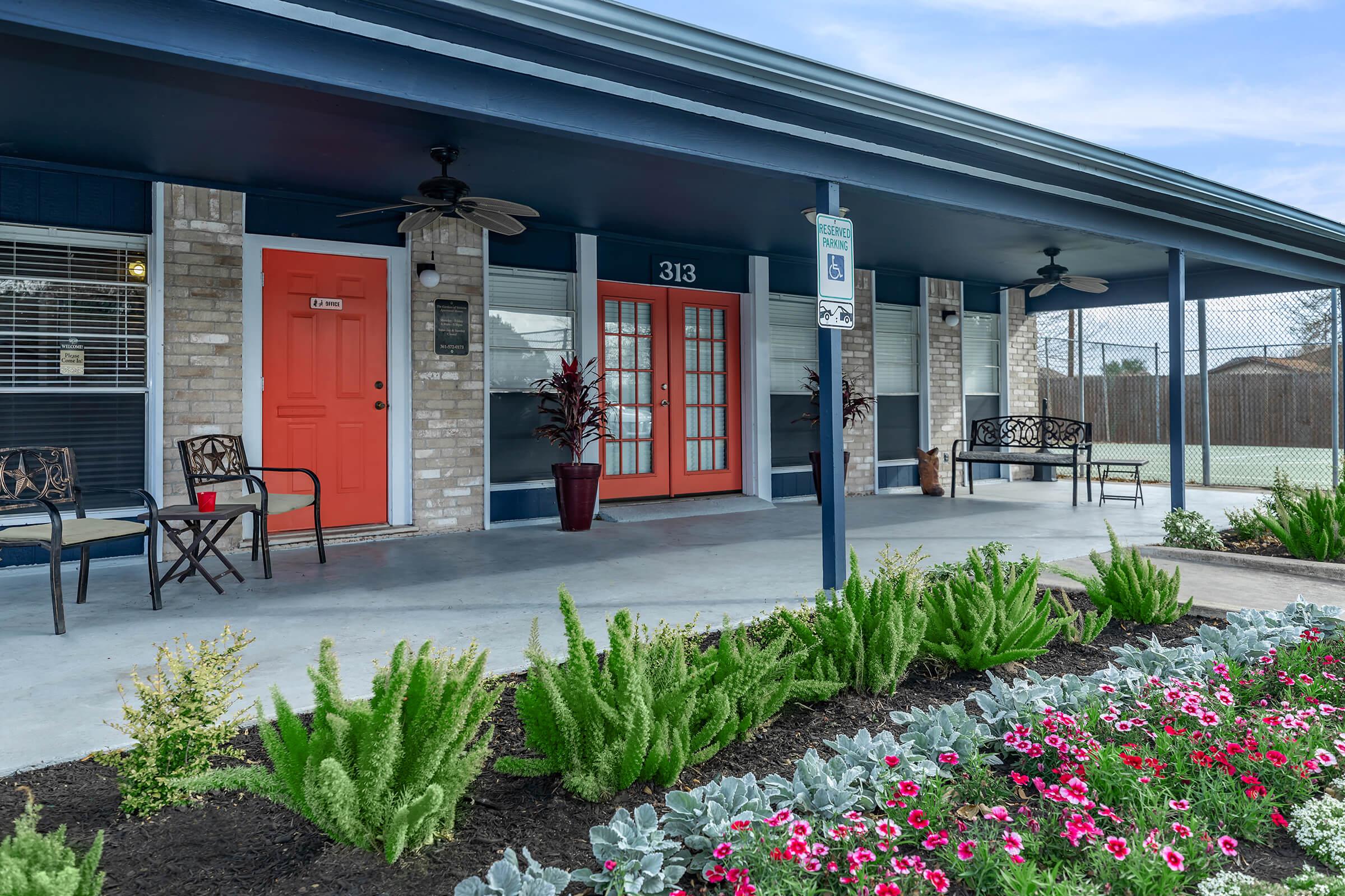 a close up of a flower garden in front of a building