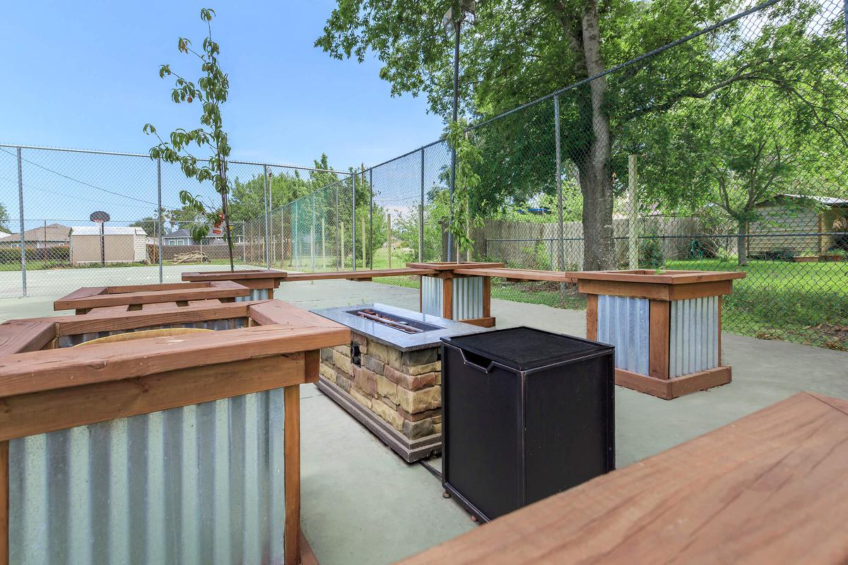 a wooden table next to a fence