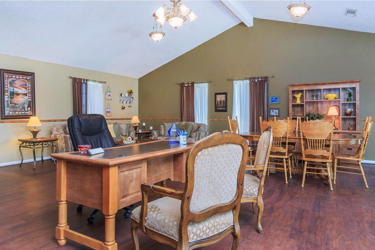 an office with a desk and chair in a room