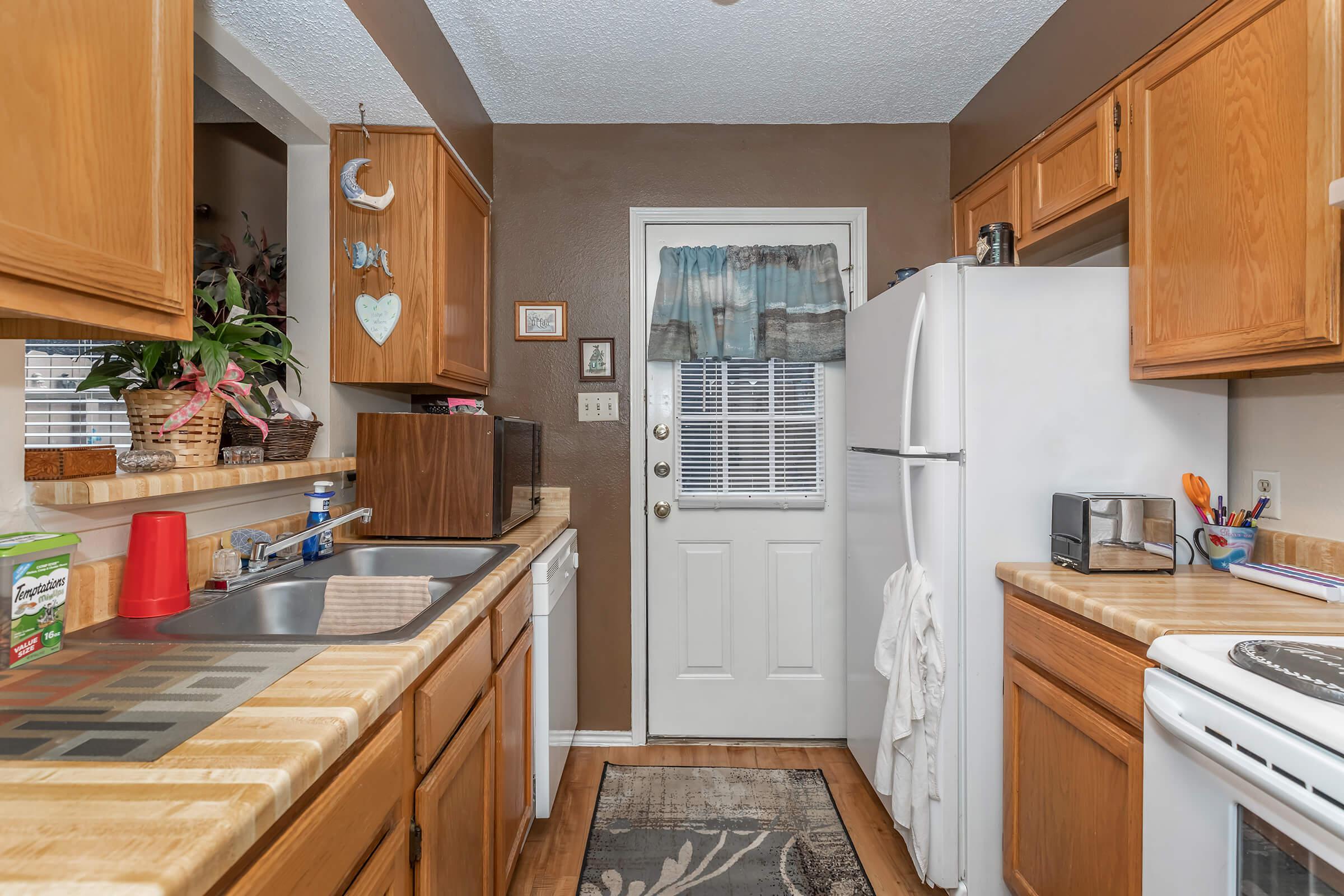 a kitchen with a stove top oven sitting inside of a wooden counter