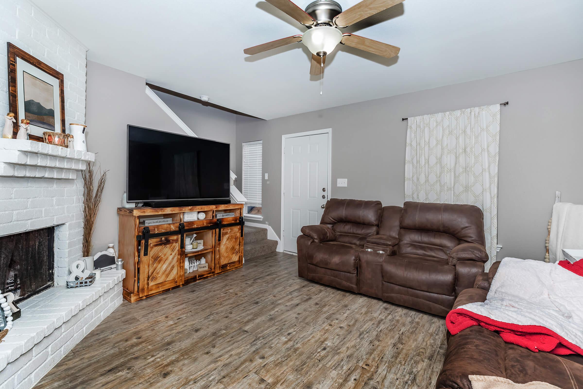 a living room filled with furniture and a fire place