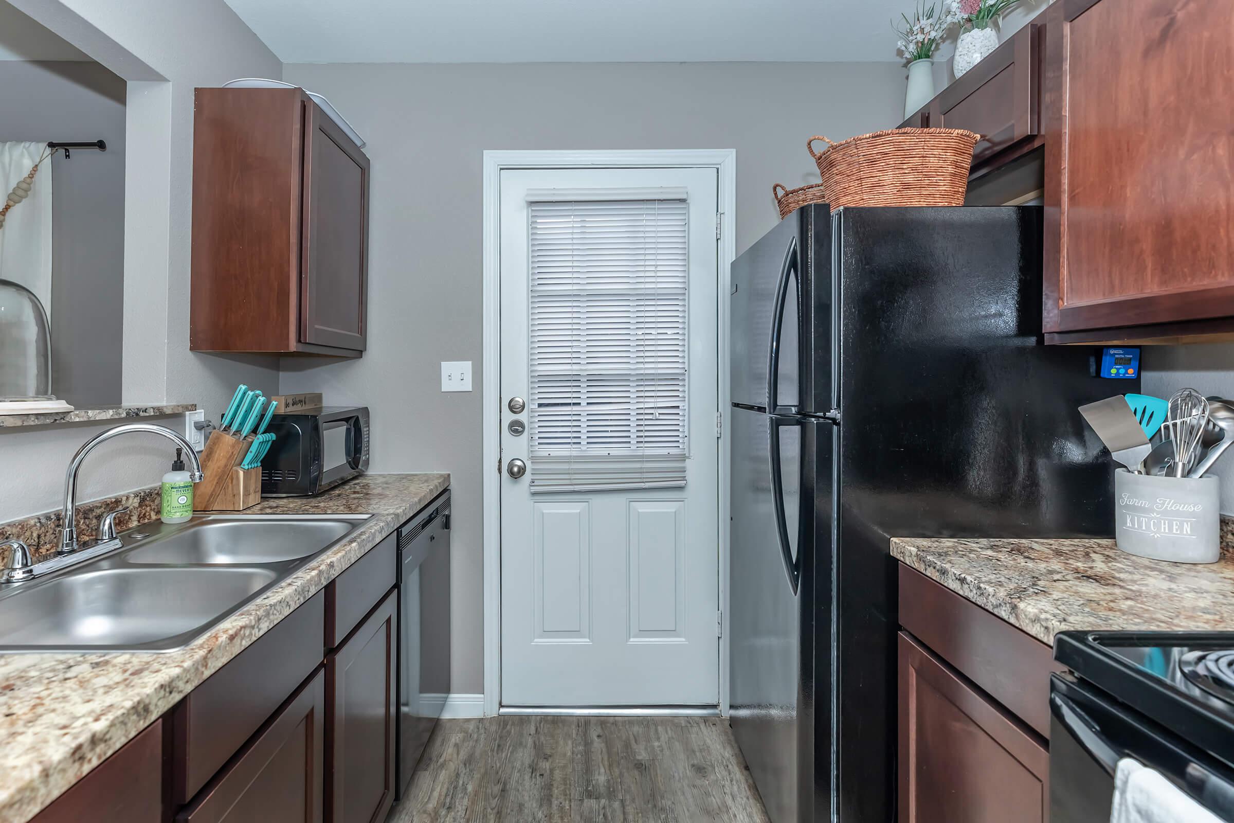 a kitchen with stainless steel appliances and wooden cabinets