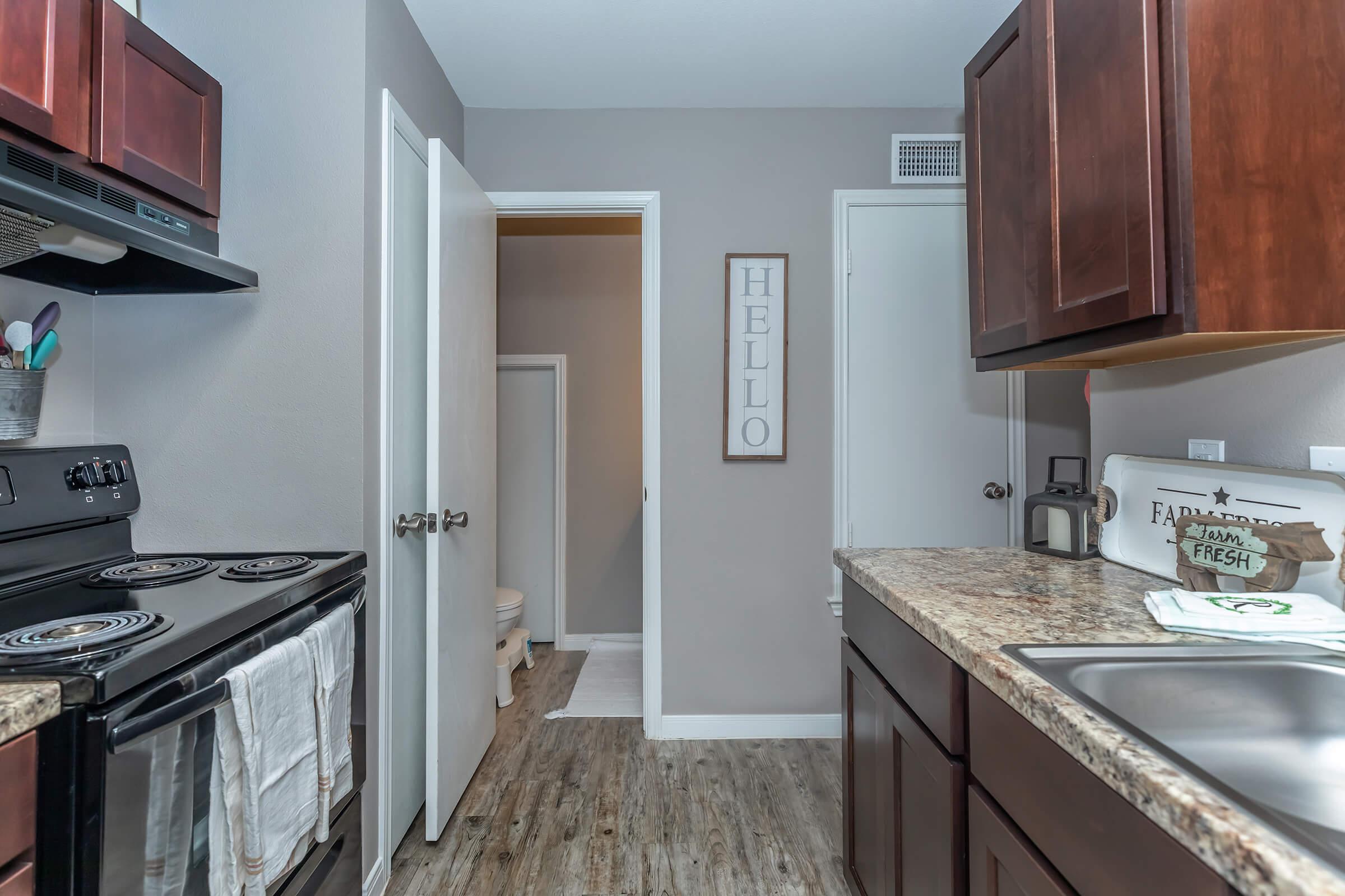 a kitchen with a stove sink and refrigerator