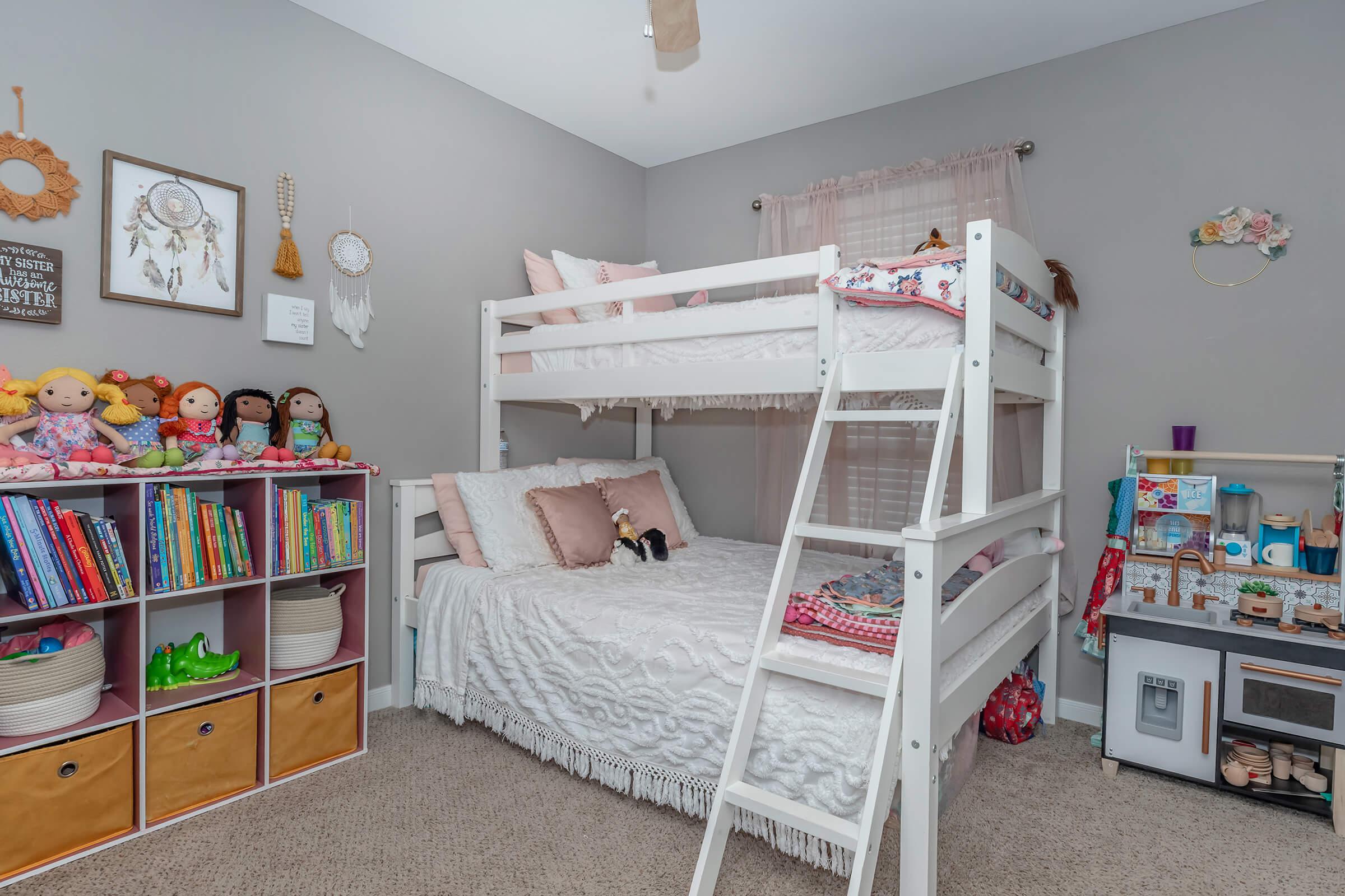 a bedroom with a bed and desk in a room