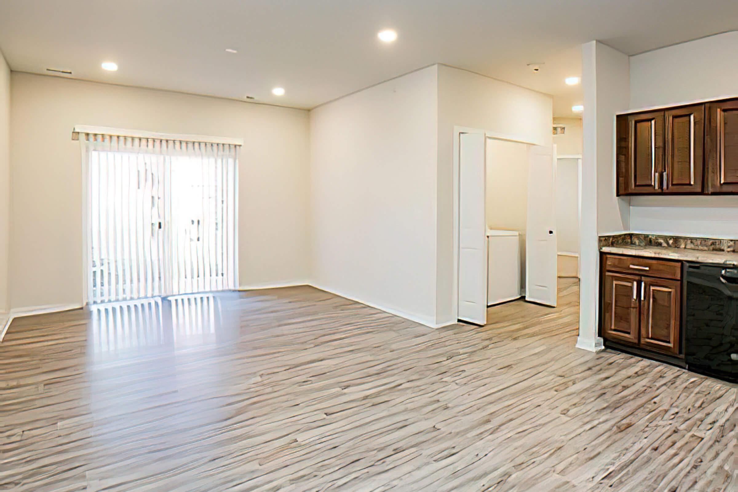 a large empty room with a wood floor