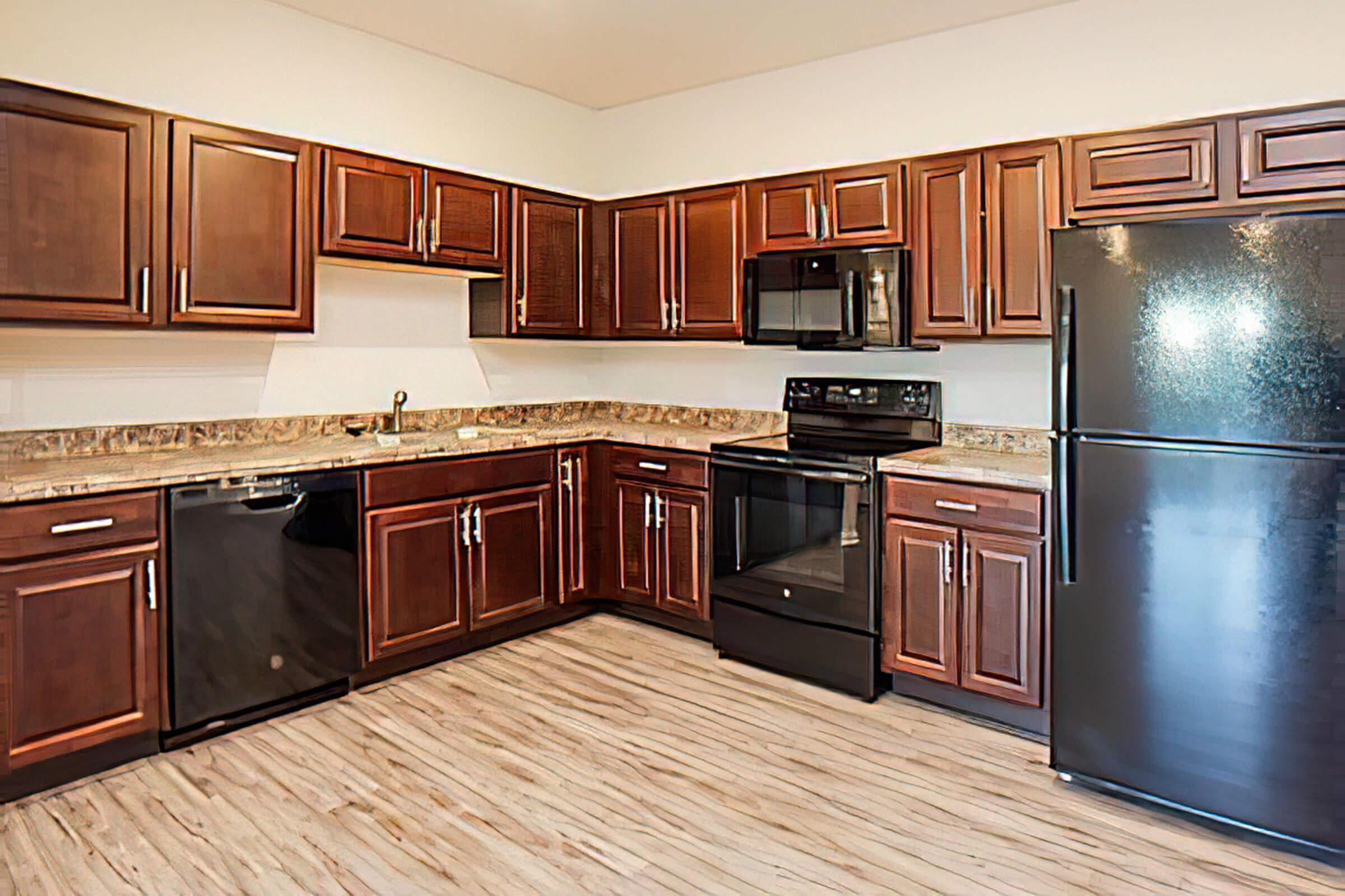 a modern kitchen with stainless steel appliances and wooden cabinets