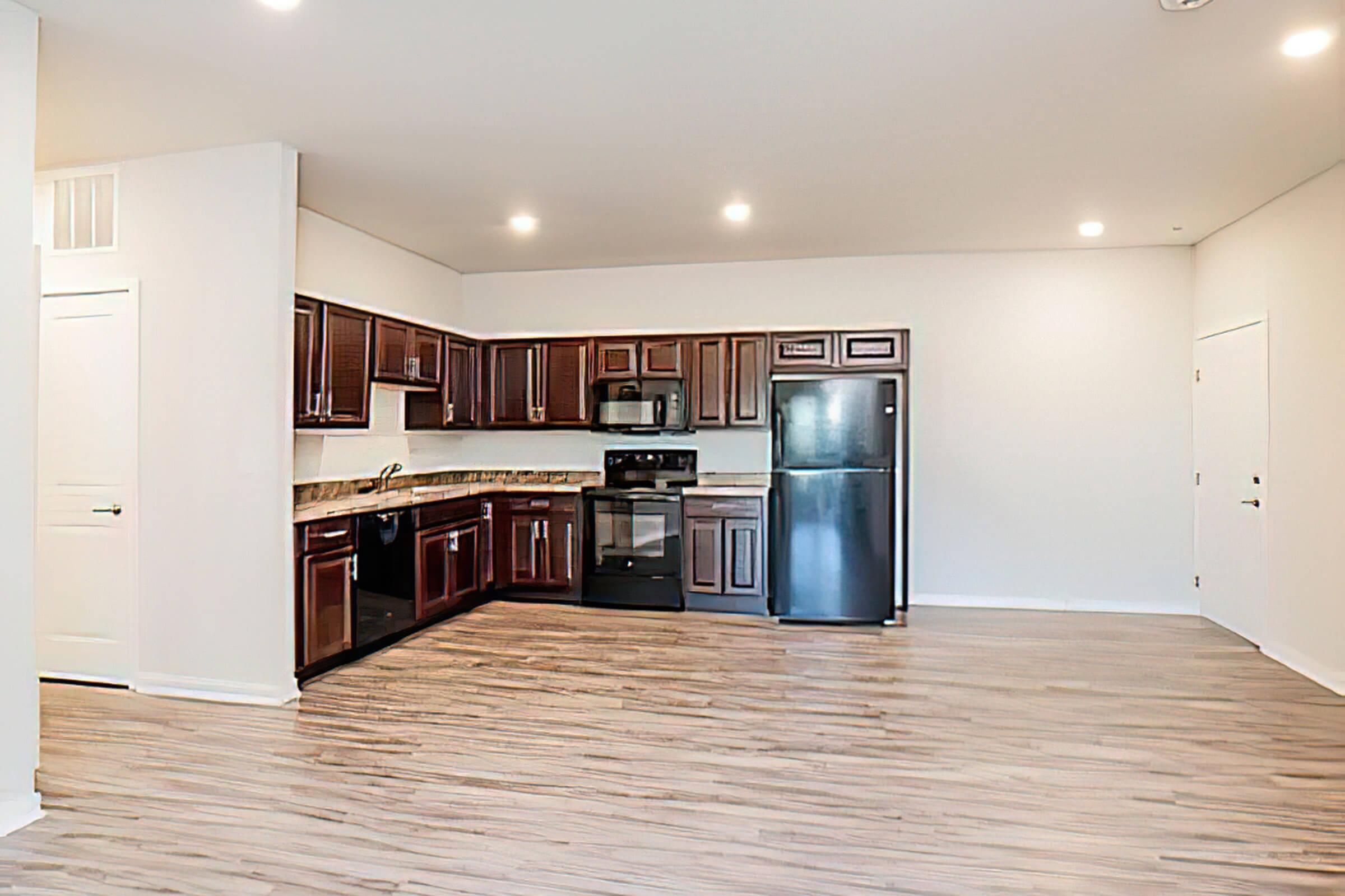 a kitchen with a wood floor in a room