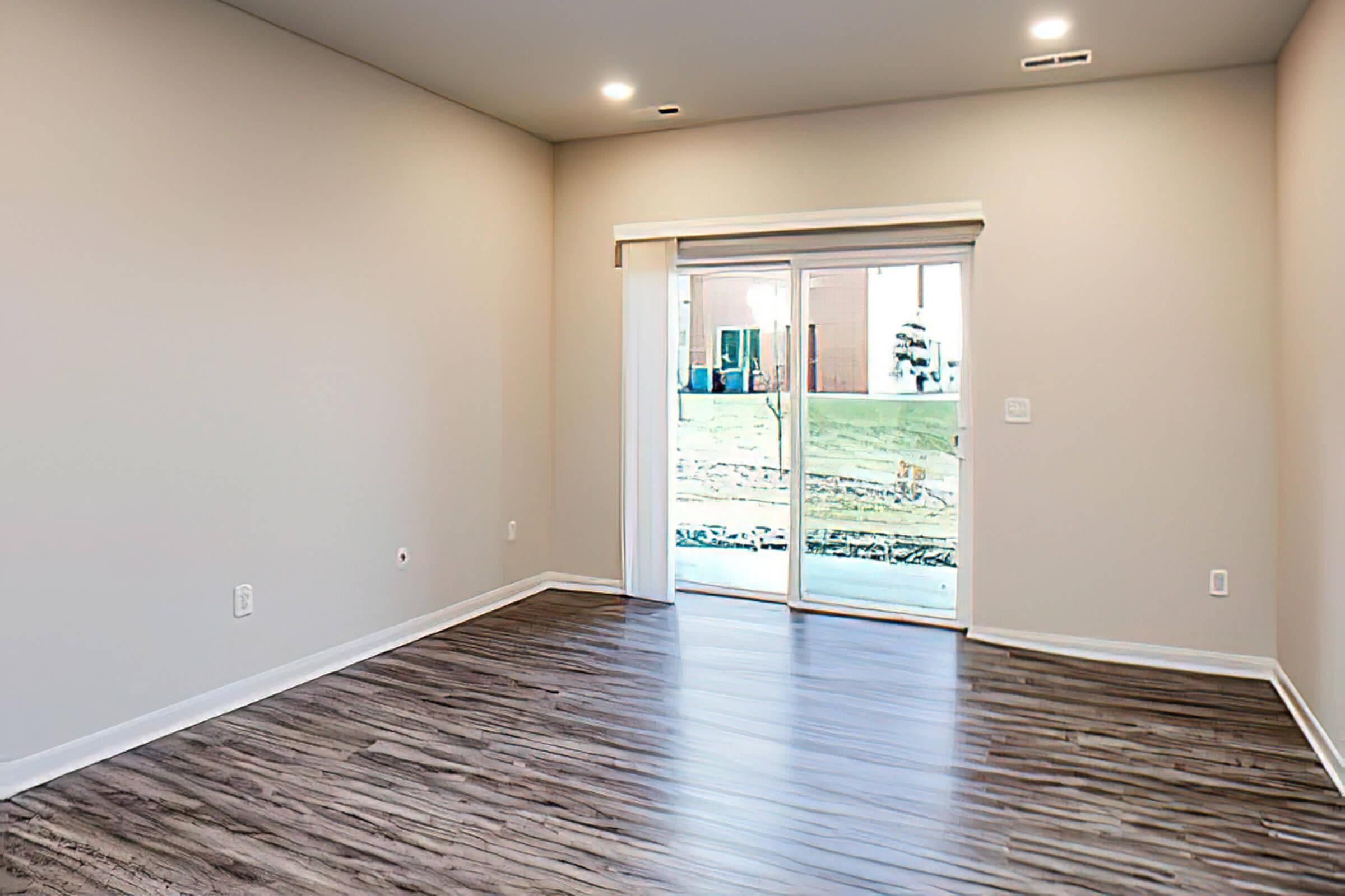 a large empty room with a wooden floor