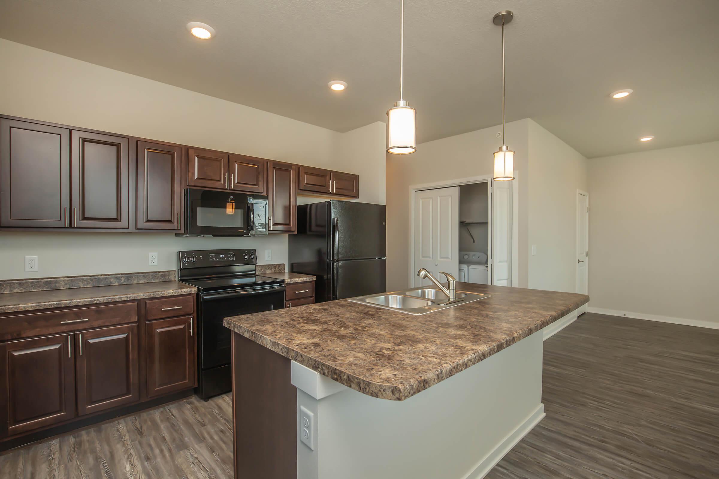 a modern kitchen with stainless steel appliances and wooden cabinets