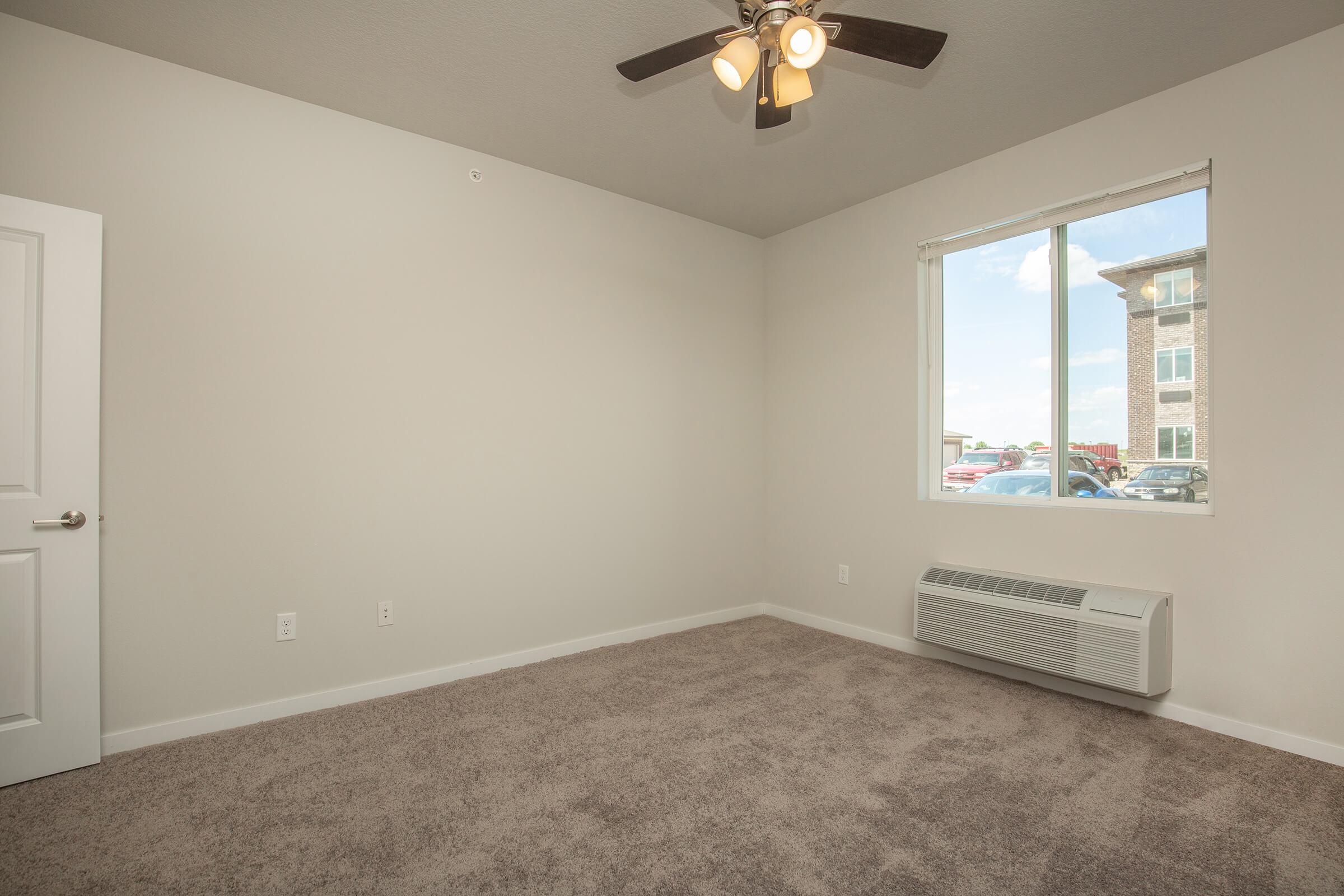 a bedroom with a large window