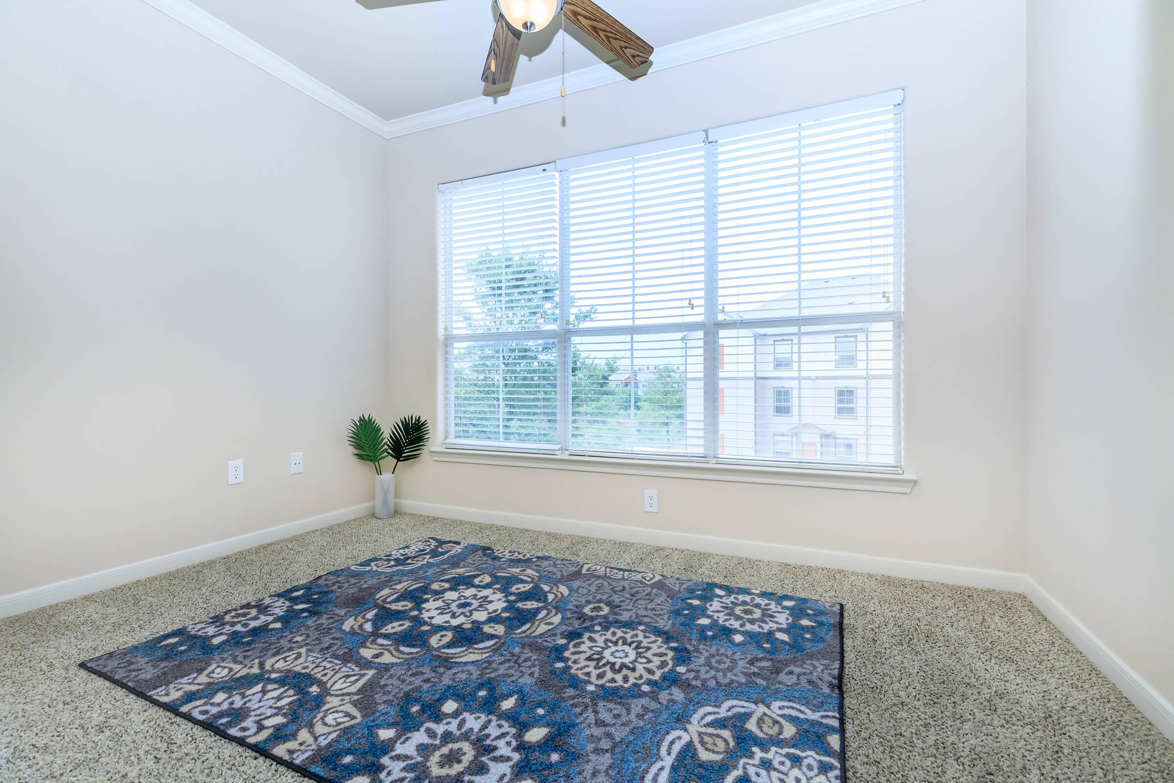 a bedroom with a large window