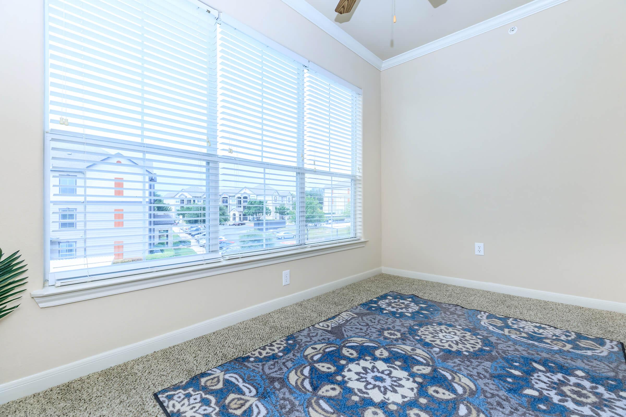 a bedroom with a large window