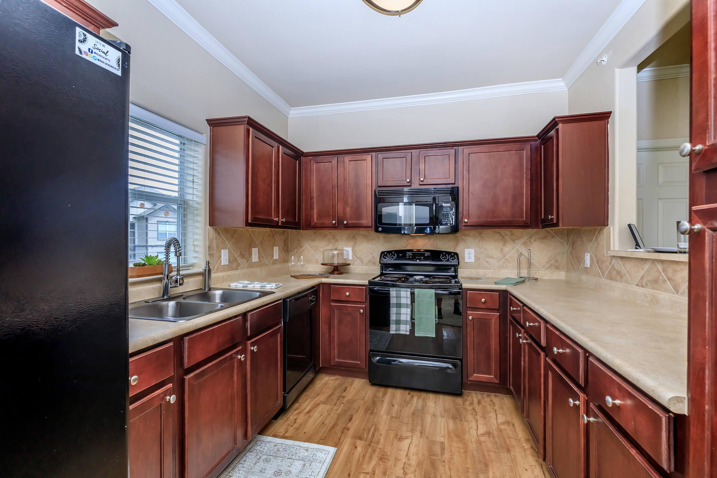 a kitchen with stainless steel appliances and wooden cabinets