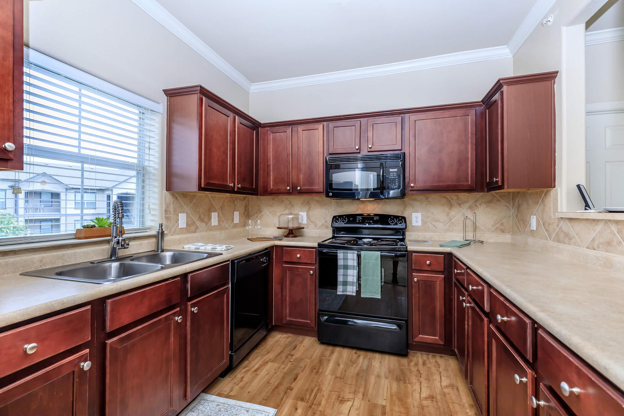 a kitchen with stainless steel appliances and wooden cabinets