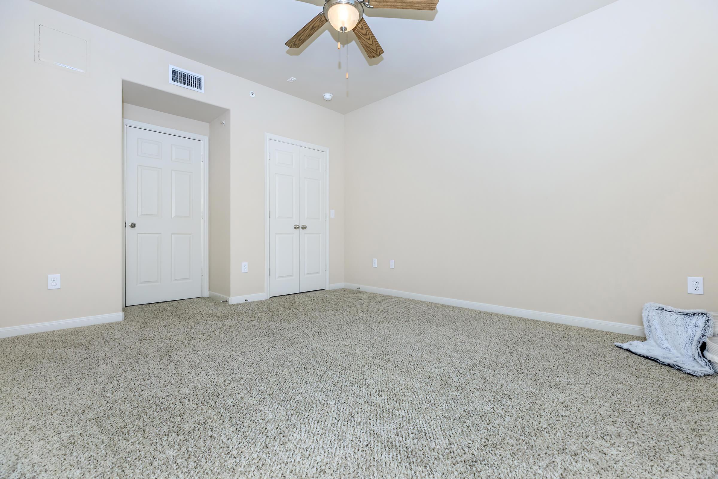 a bedroom with a bed and a mirror