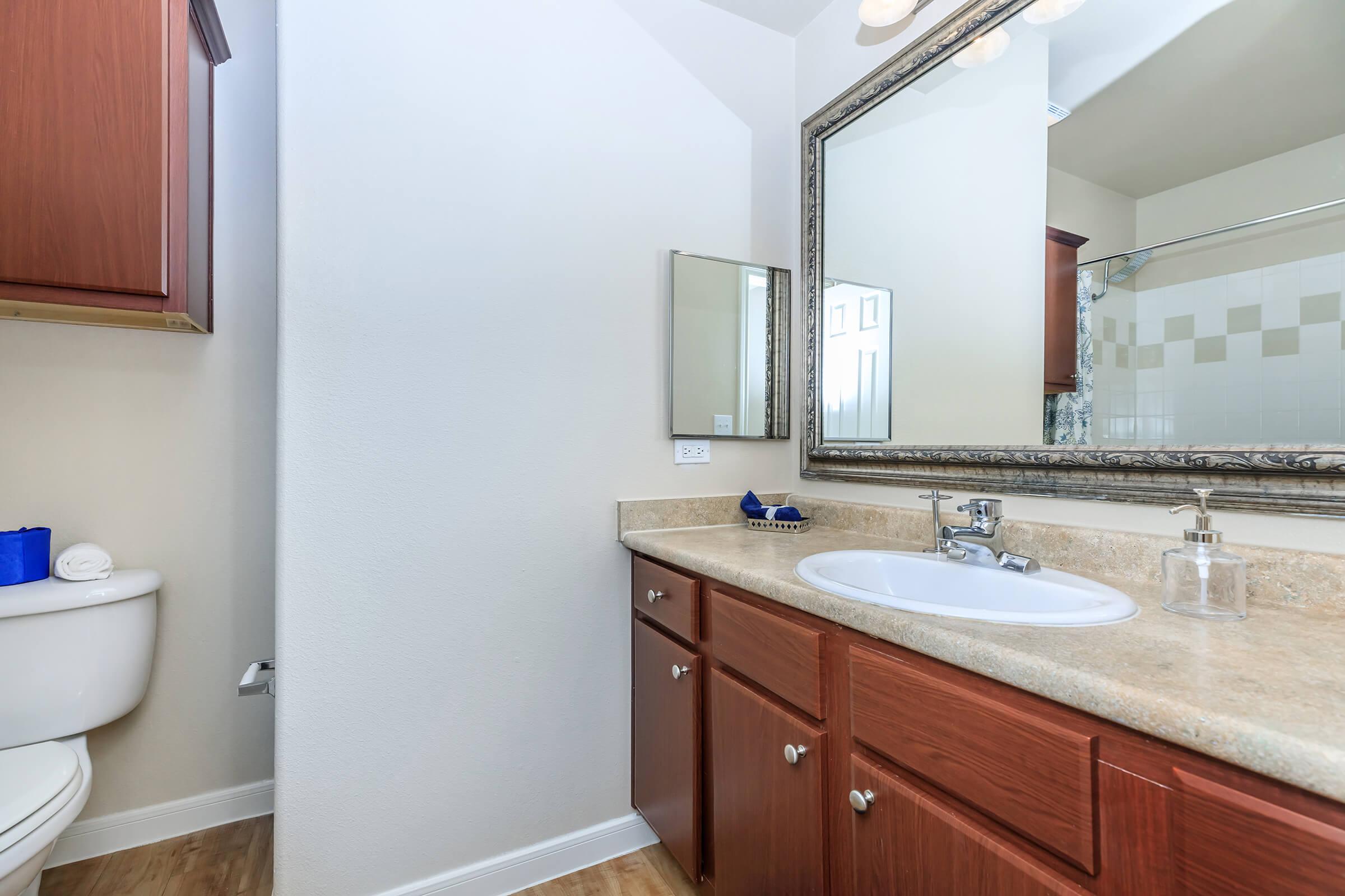 a kitchen with a sink and a mirror