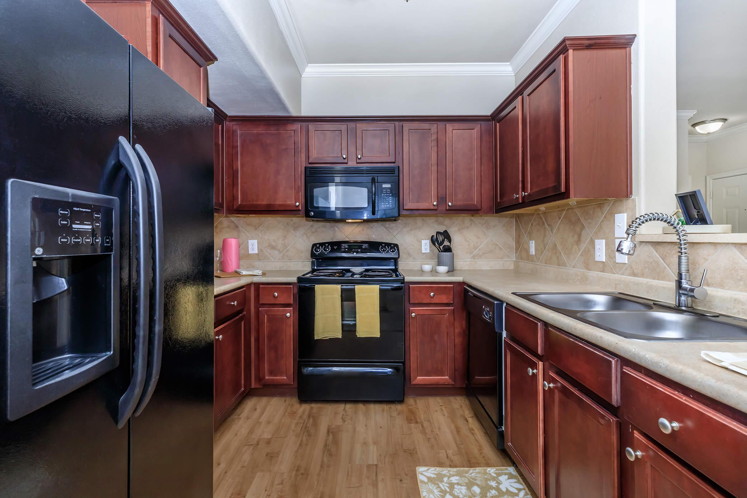 a kitchen with stainless steel appliances and wooden cabinets
