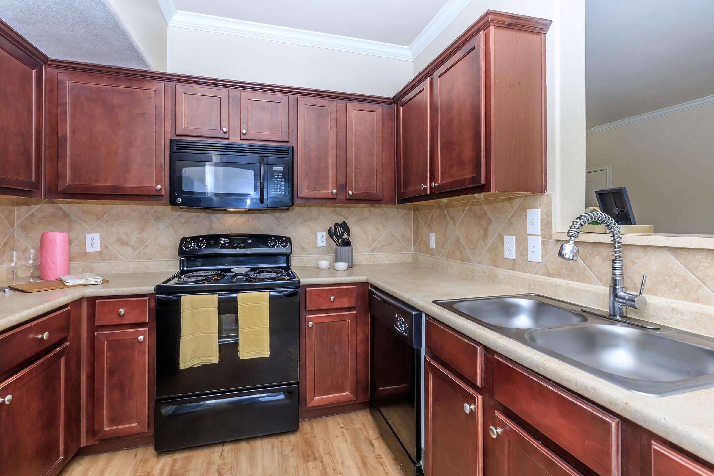 a kitchen with stainless steel appliances and wooden cabinets