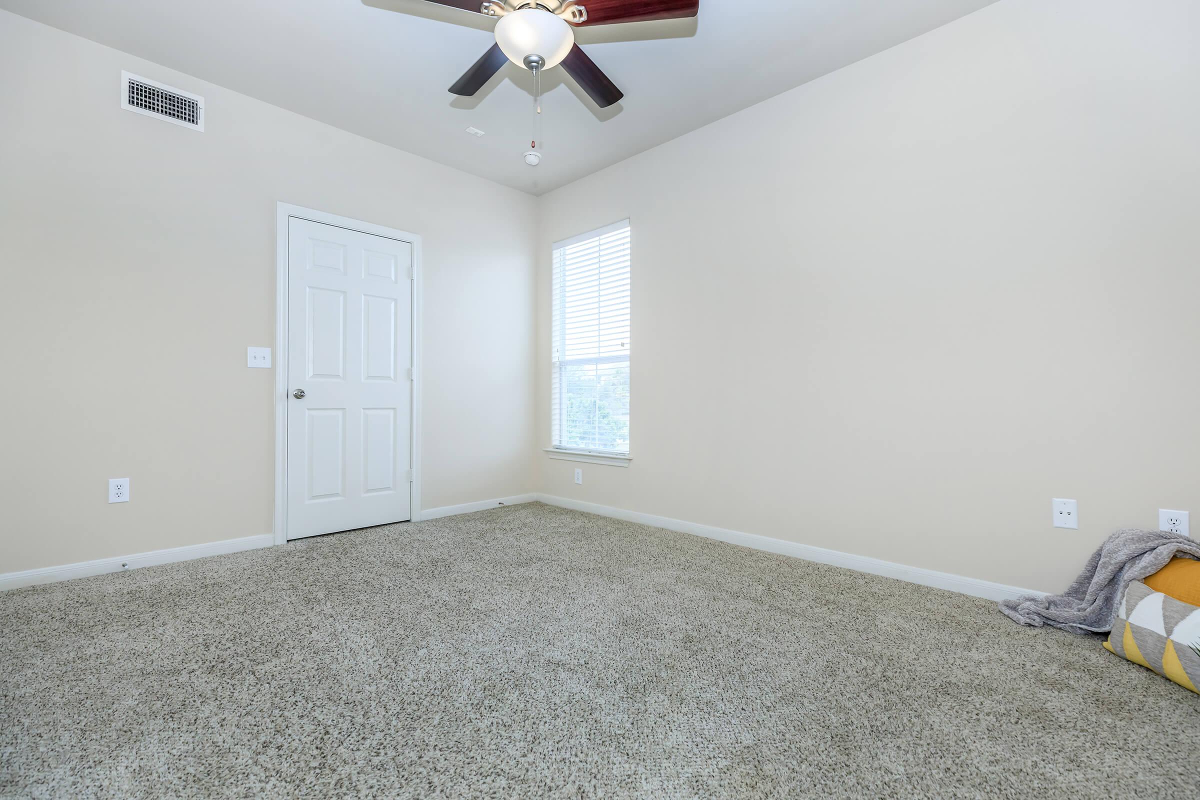 a bedroom with a bed and a mirror