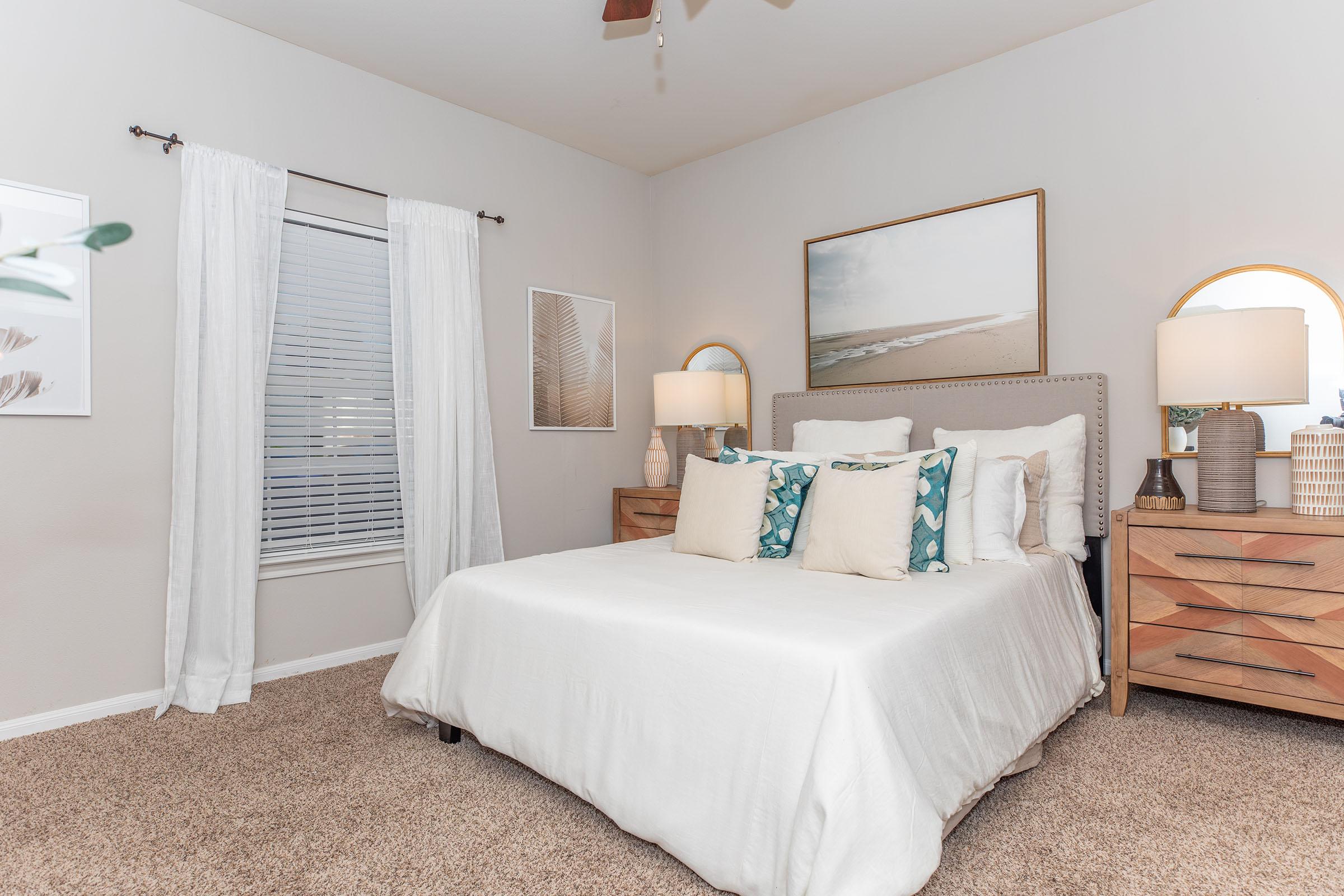 a bedroom with a bed and desk in a room