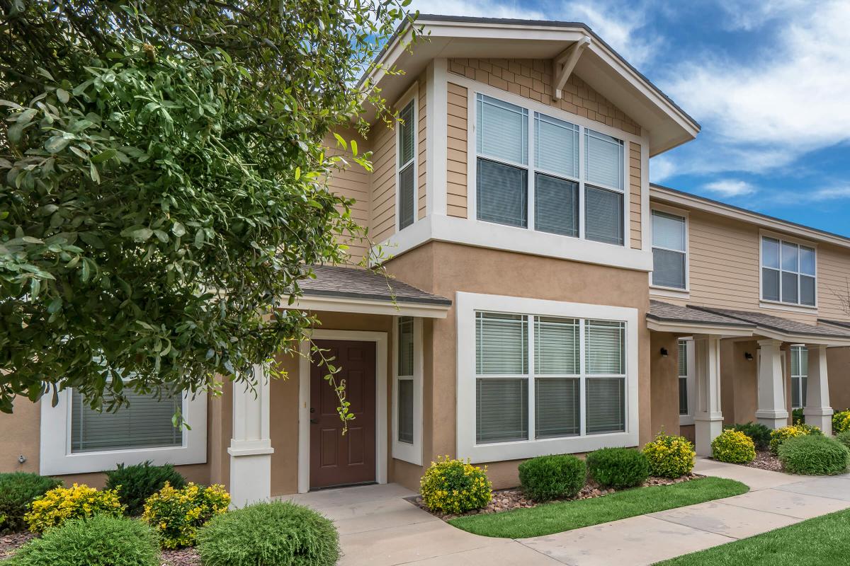 a house with bushes in front of a building