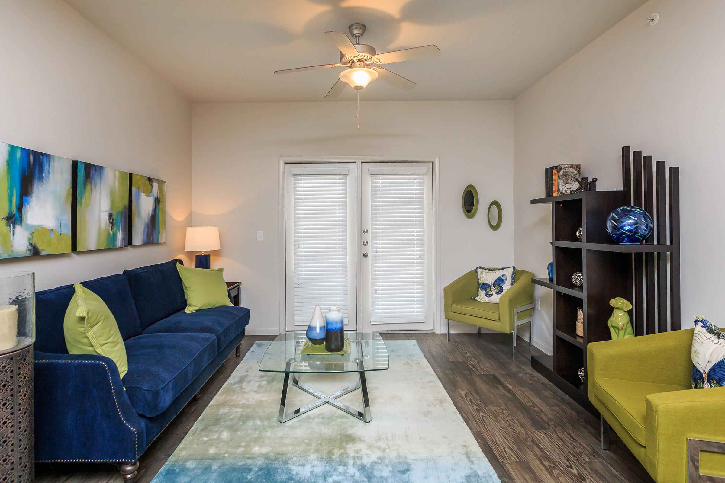 a living room filled with furniture and a lamp