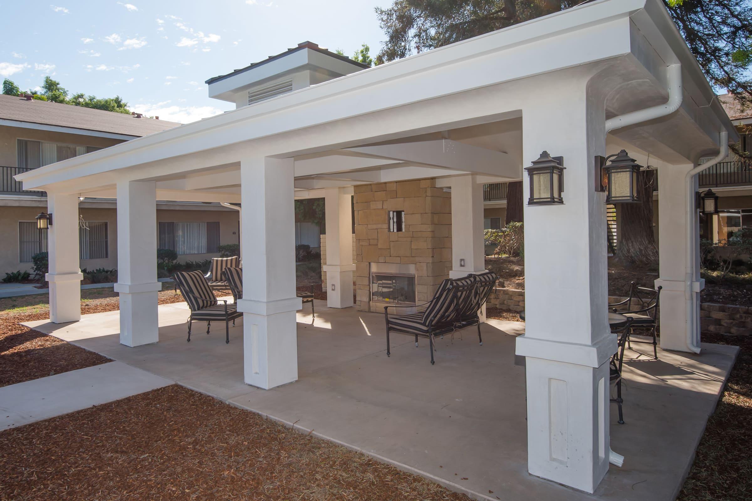 outdoor furniture around a fireplace